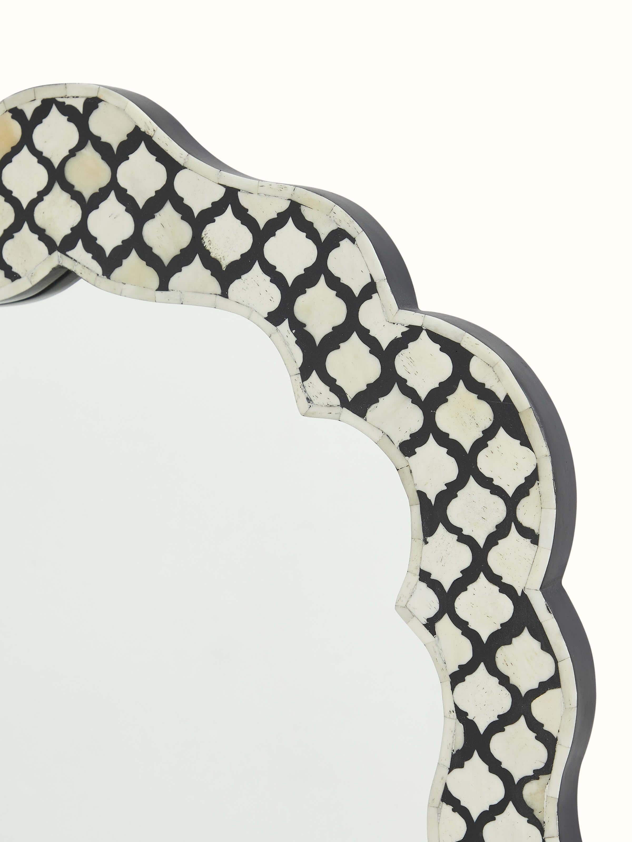 Angled view of bone inlaid wall mirror, emphasizing the elegant design and overall appearance of the piece.