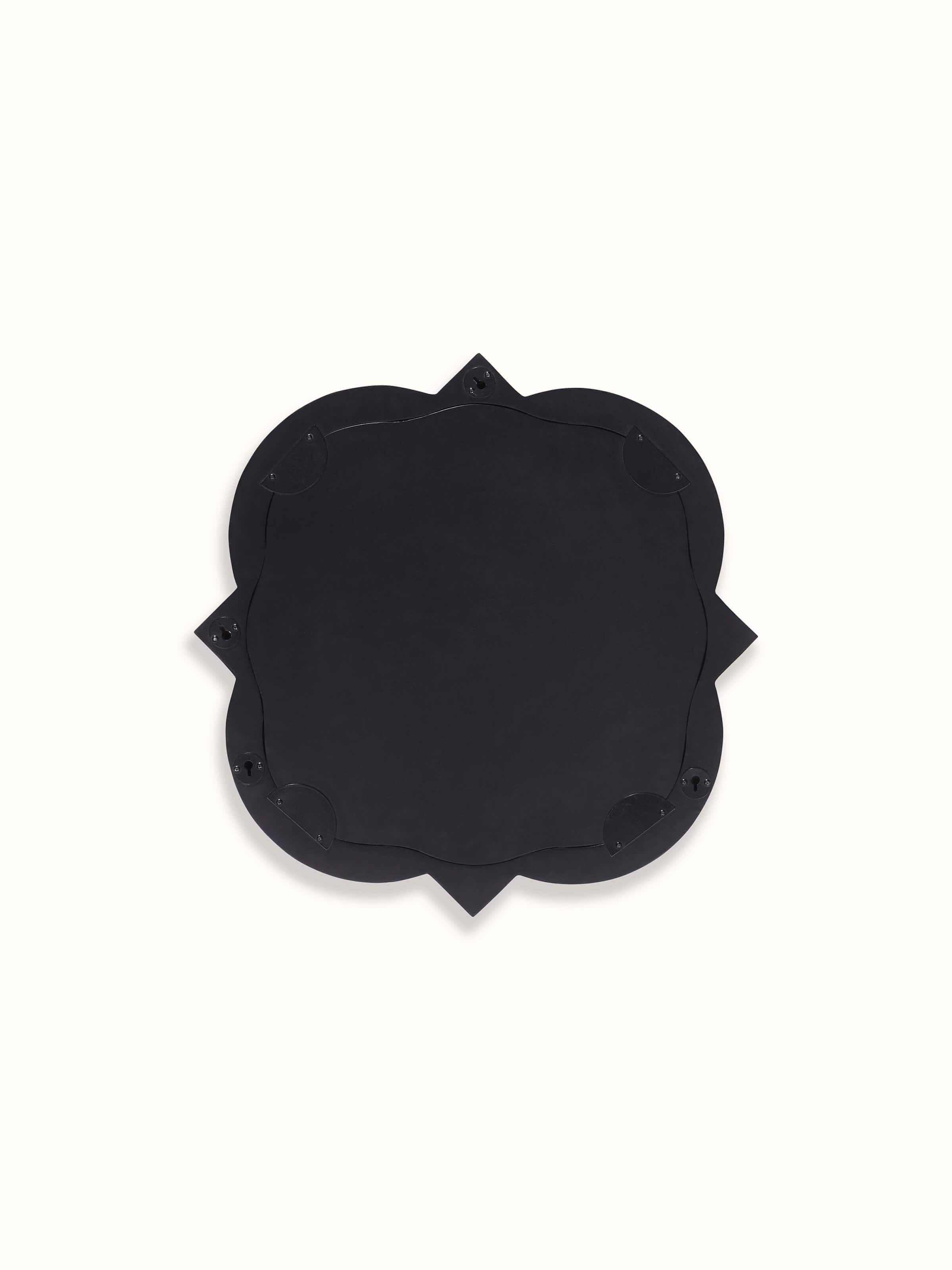 Detailed view of the mirror's frame, showcasing the elegant bone inlay work and the quatrefoil shape