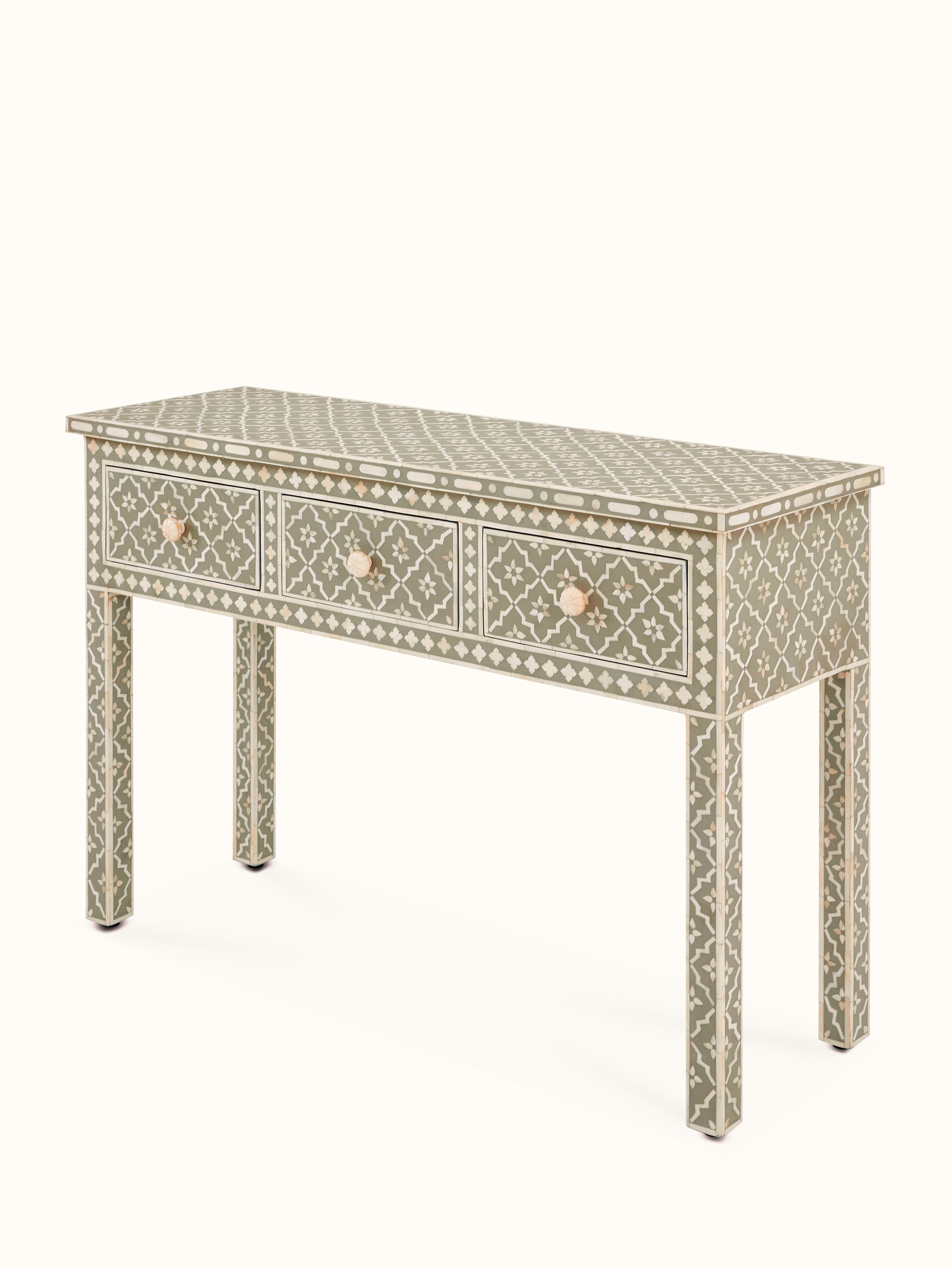 Close-up of the bone inlay patterns on the console table surface