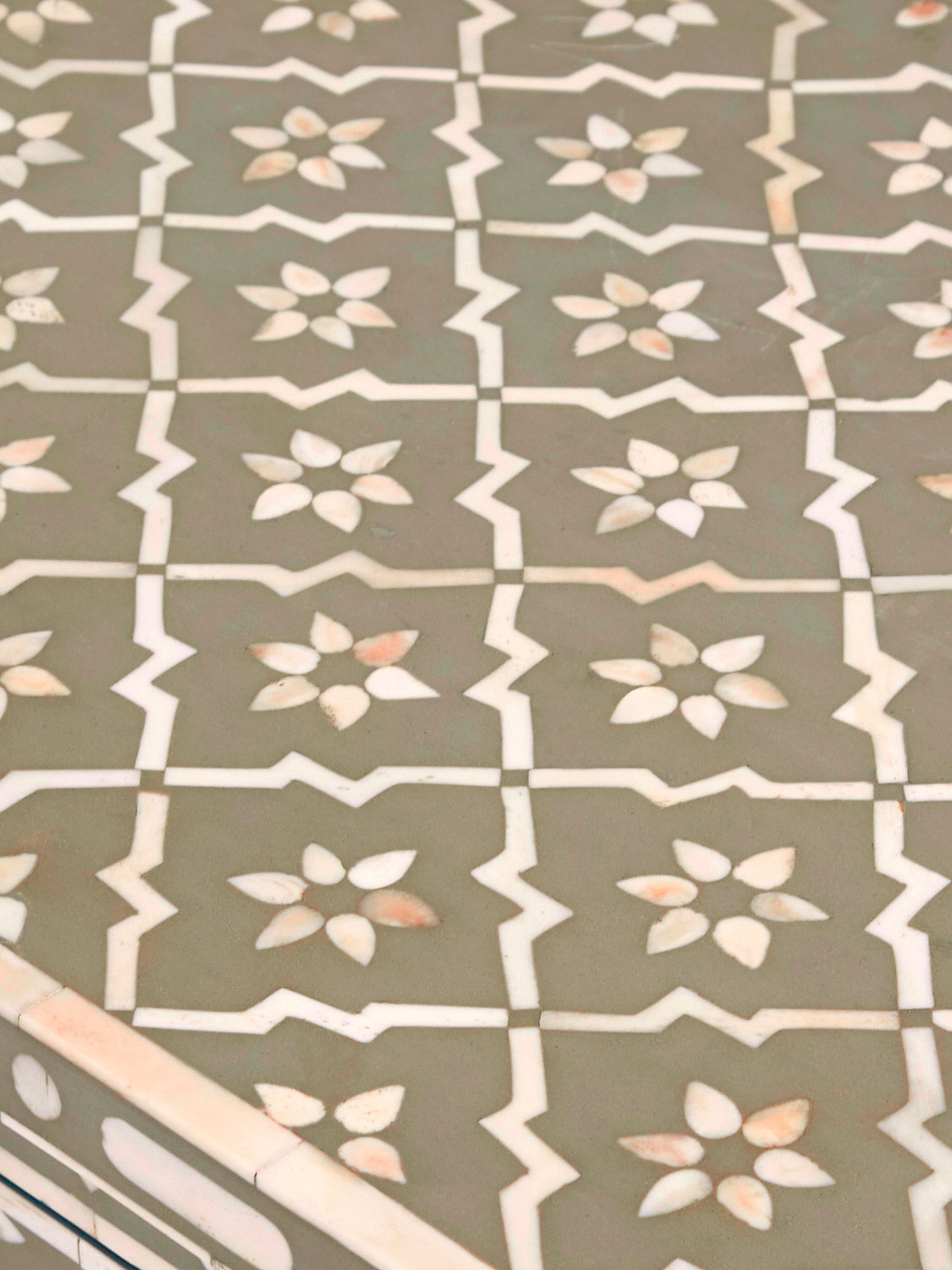 View of the console table showcasing the bone inlaid top and sturdy legs