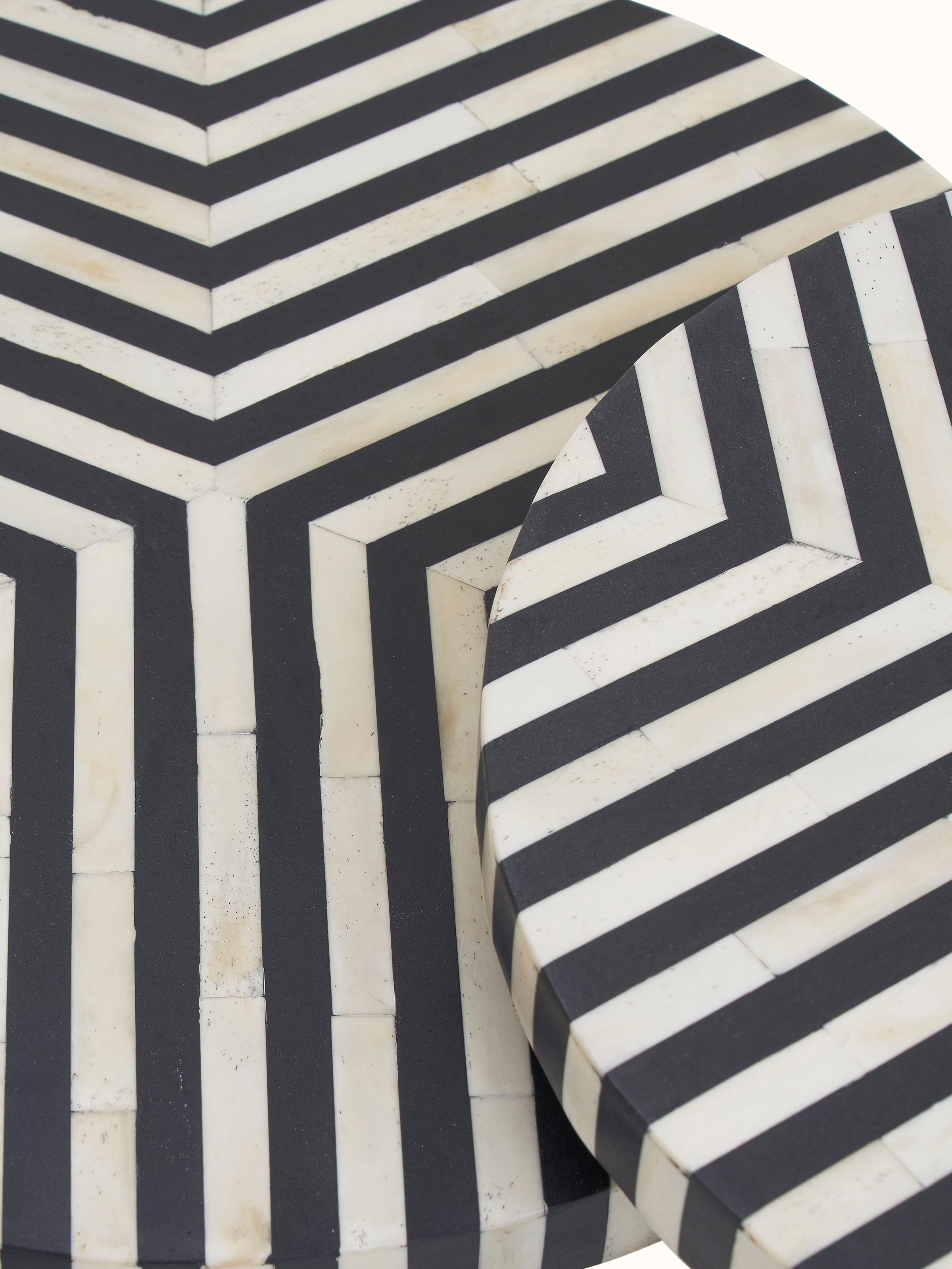 Close-up of the bone inlaid pattern on the nesting tables, focusing on the craftsmanship