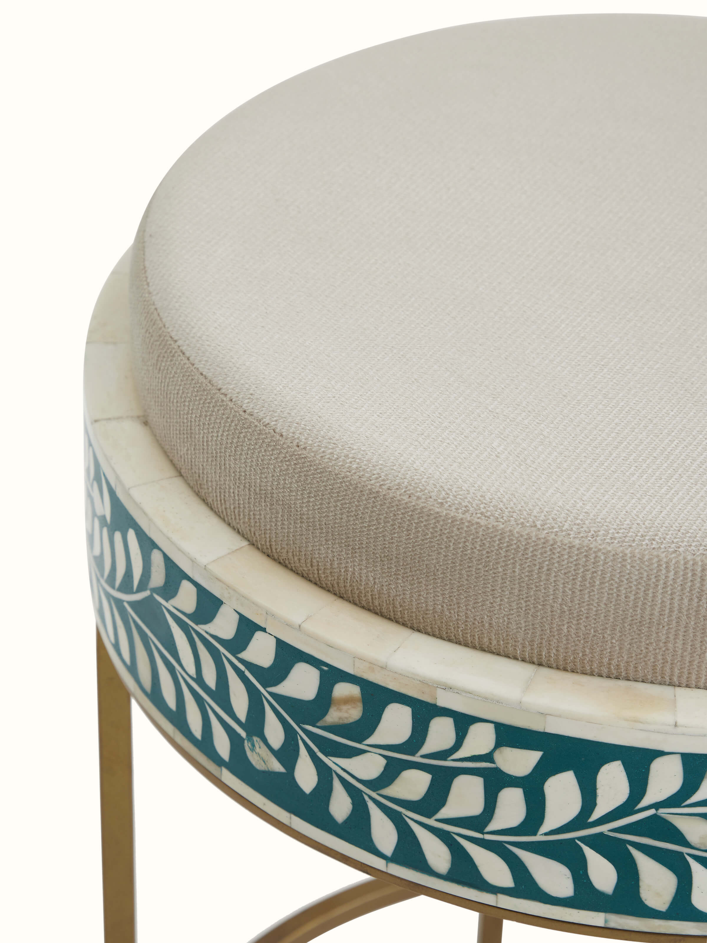 Close-up of the bone inlay design on the upholstered metal stool, highlighting the detailed craftsmanship and aesthetic appeal.