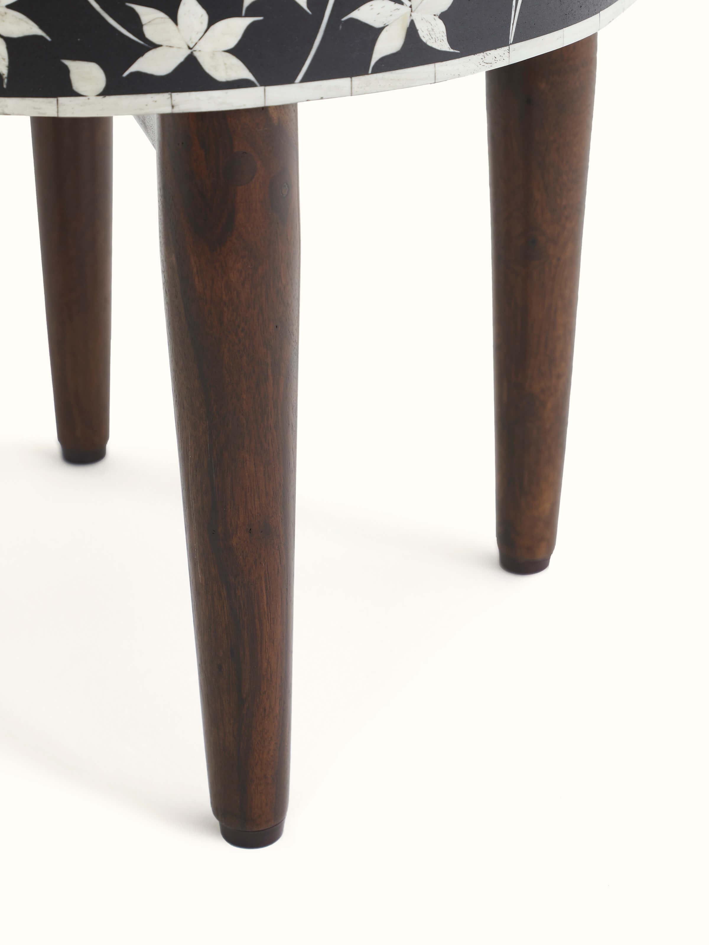 Detailed shot of the bone inlay pattern on the Sheesham wood stool, showcasing the fine craftsmanship and design.