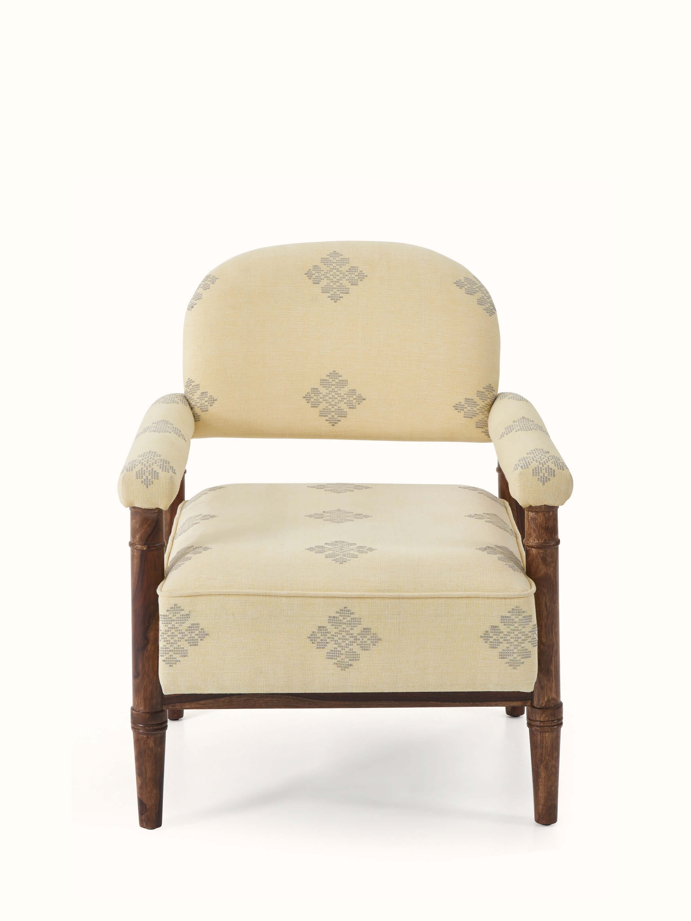 Front view of upholstered sheesham wood Bawan Buti armchair with intricate design
