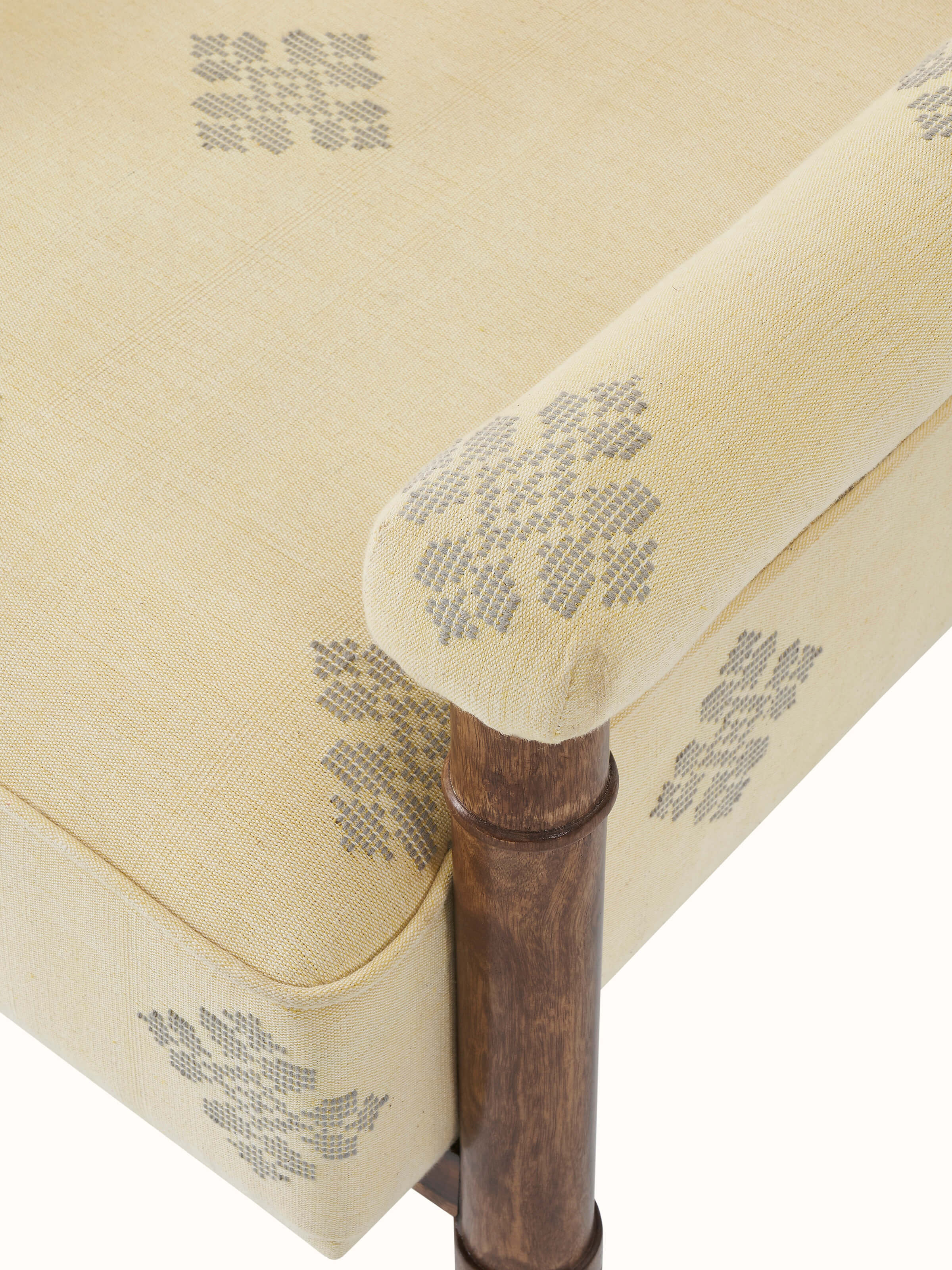 Close-up view of the armrest and upholstery stitching on the Bawan Buti armchair