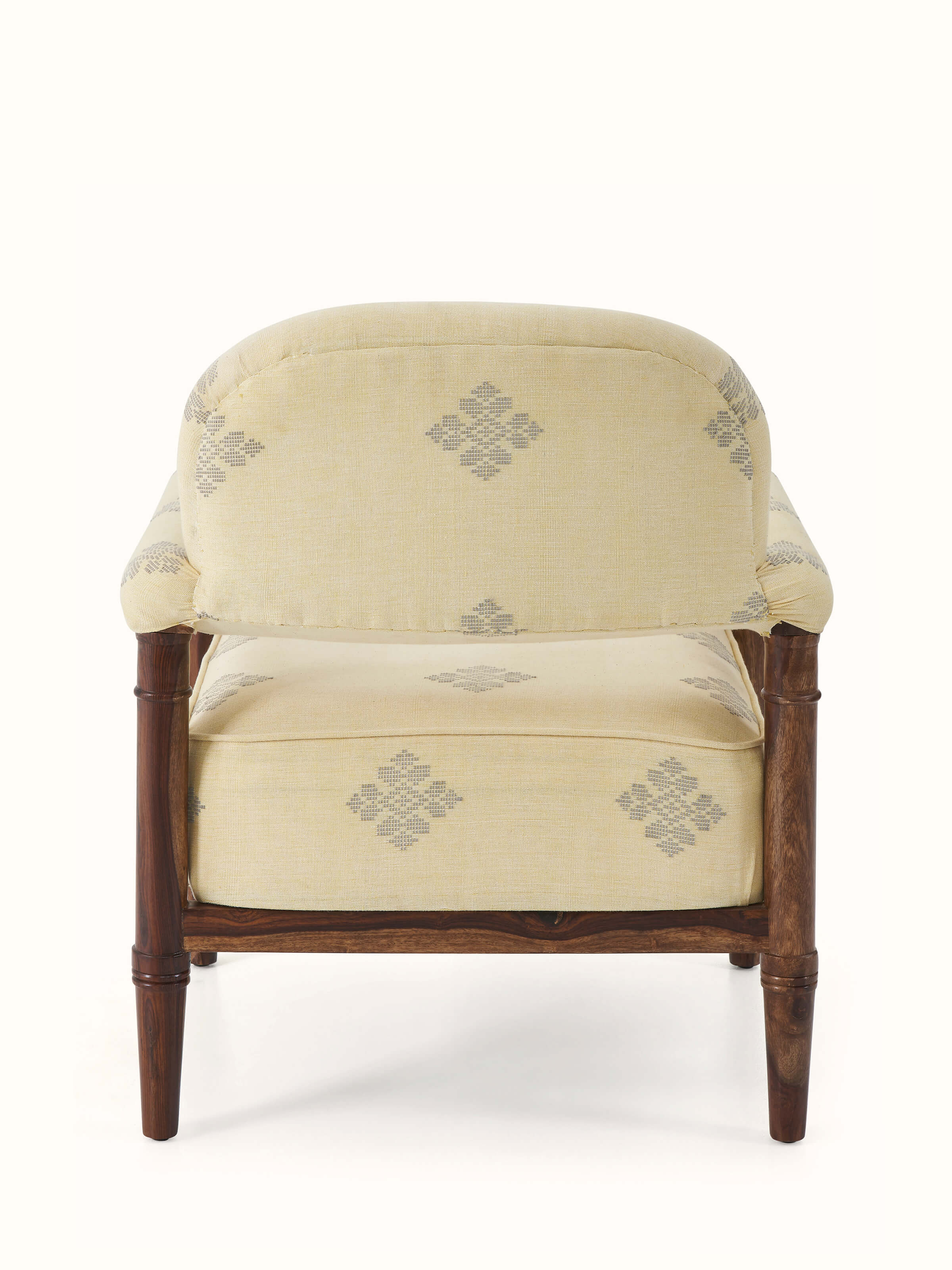 Angle view of the upholstered sheesham wood armchair showcasing its design and structure