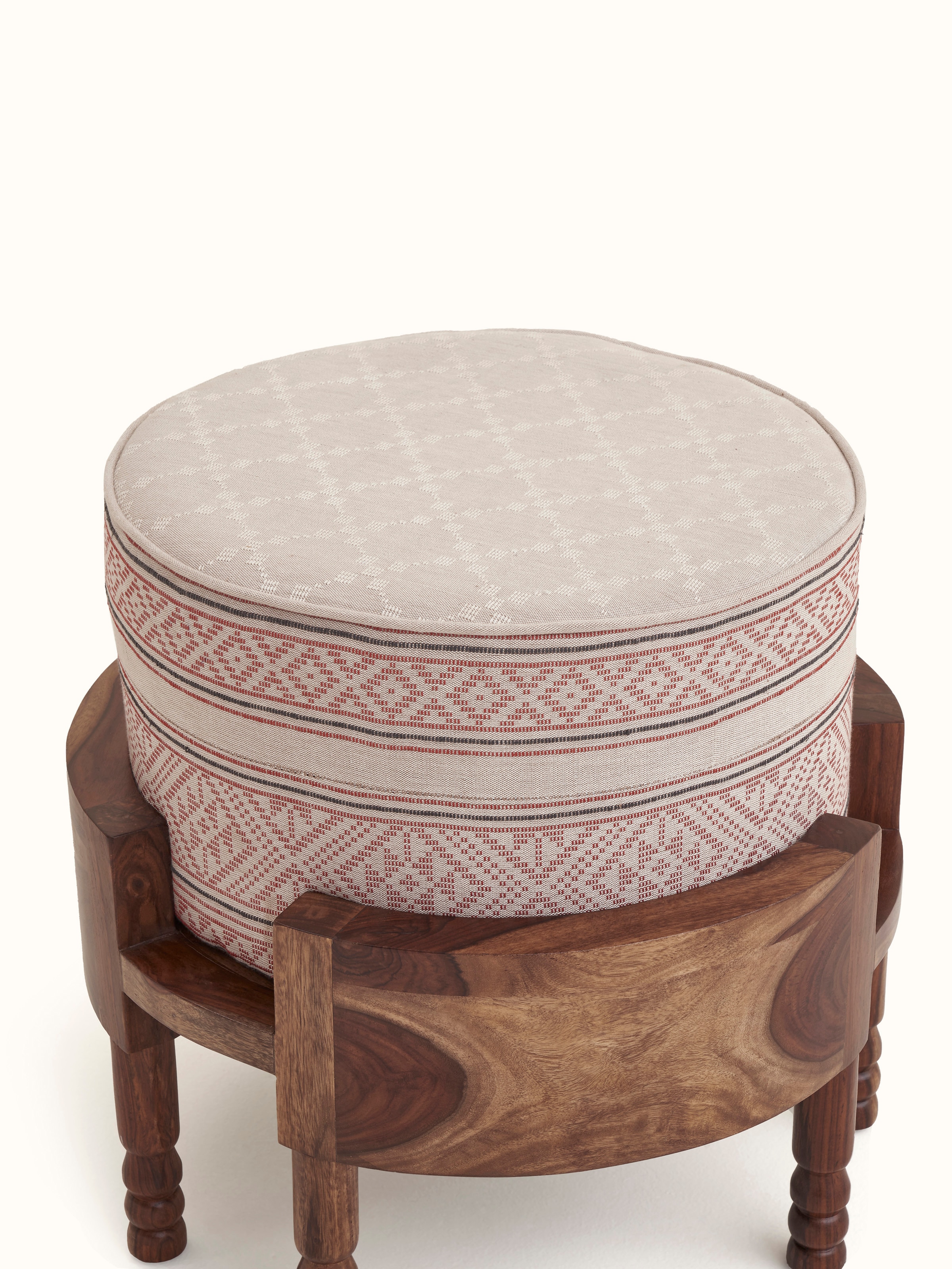Angled view of Bawan Buti upholstered Sheesham wood ottoman showcasing the detailed fabric pattern