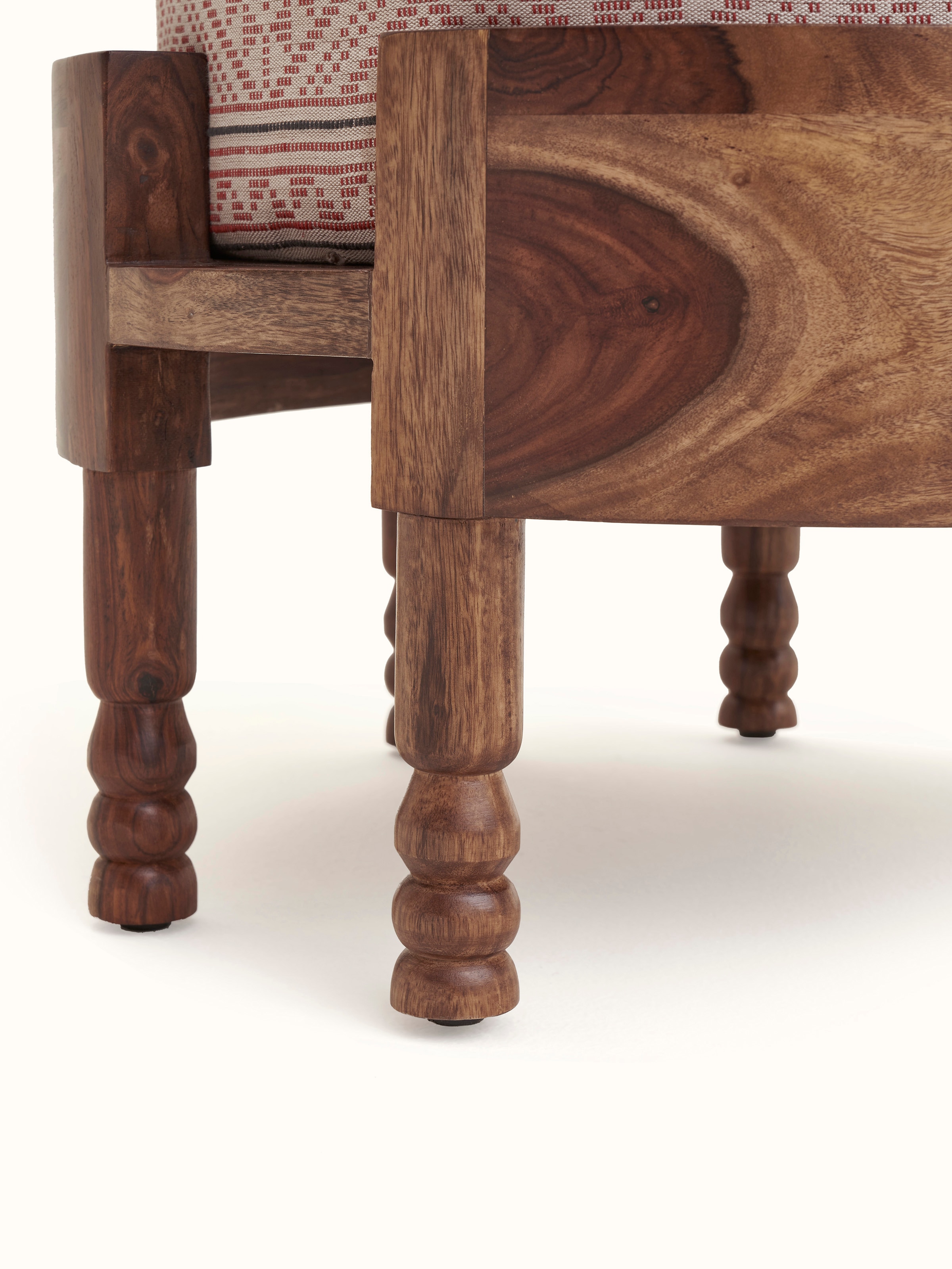 Close-up of Bawan Buti upholstered Sheesham wood ottoman focusing on the upholstery texture