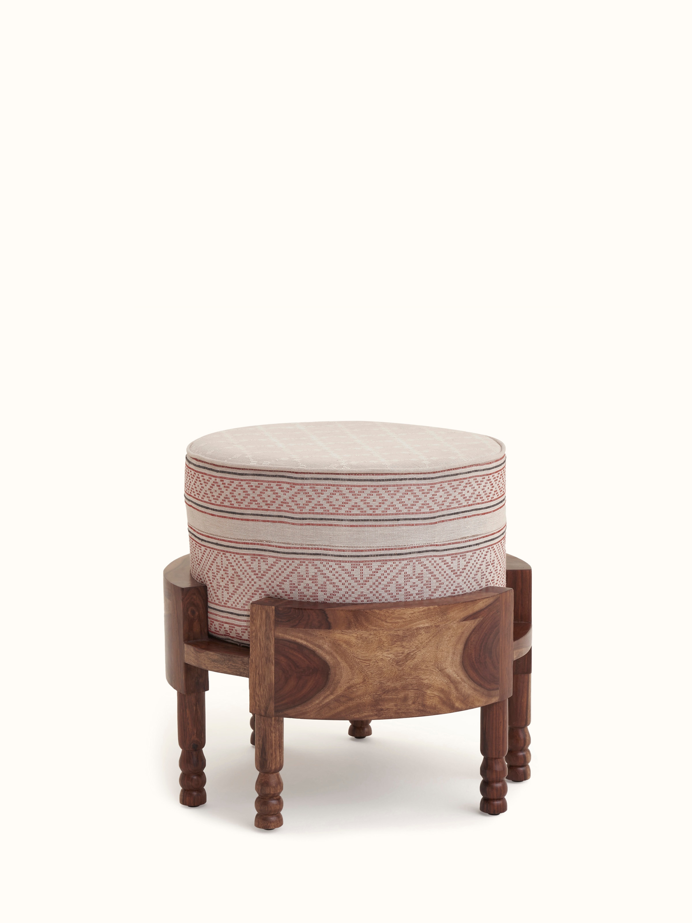 Detailed view of Bawan Buti upholstered Sheesham wood ottoman displaying the fabric and carving details