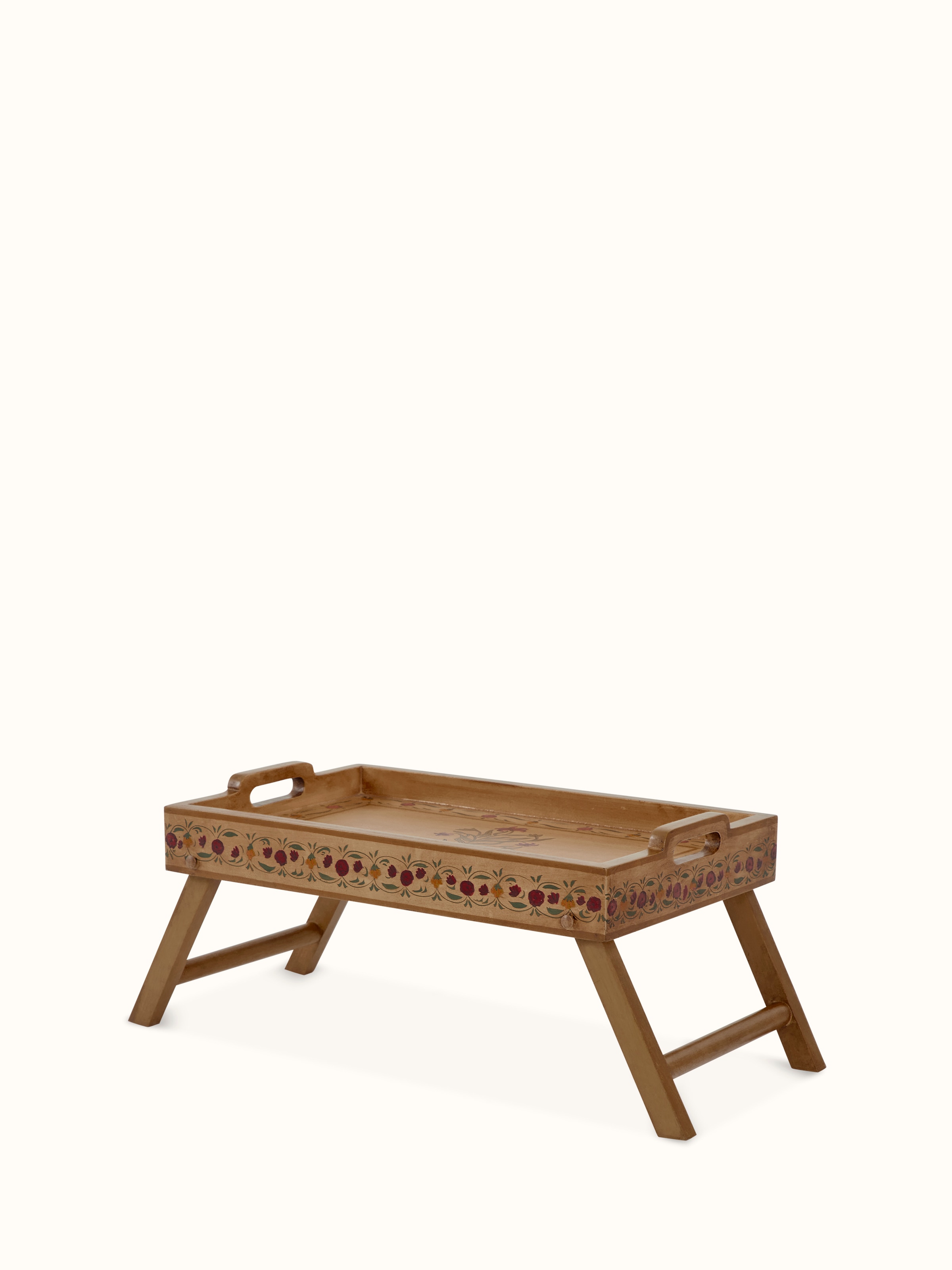 Angled view of miniature painted portable table showing the intricate paint details