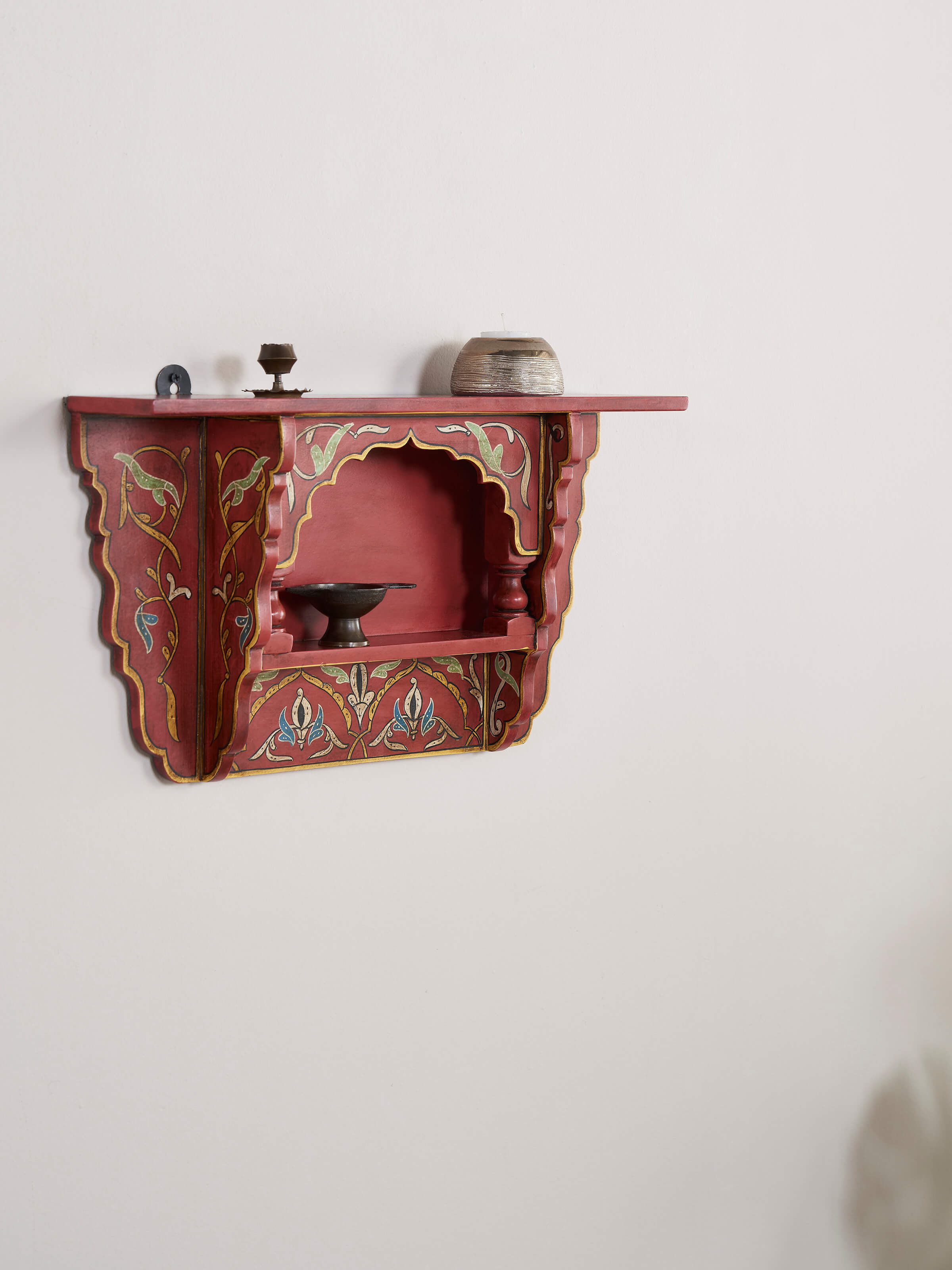 Side view of the brown miniature painted wall shelf, showcasing its detailing and wall-mounted design.