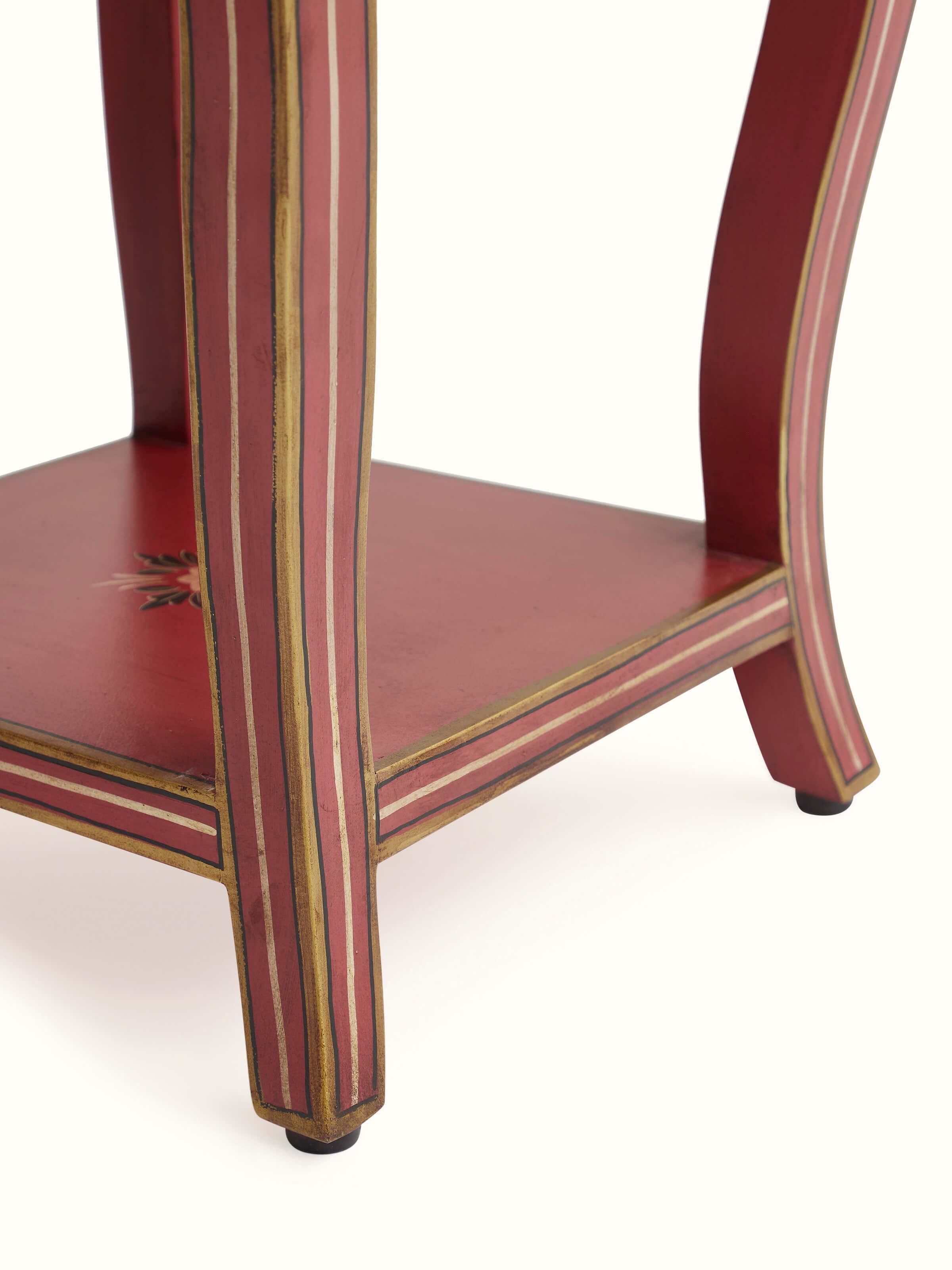 Angled view of the mango wood miniature painted end & side table in a room setting, demonstrating its use as a decorative piece