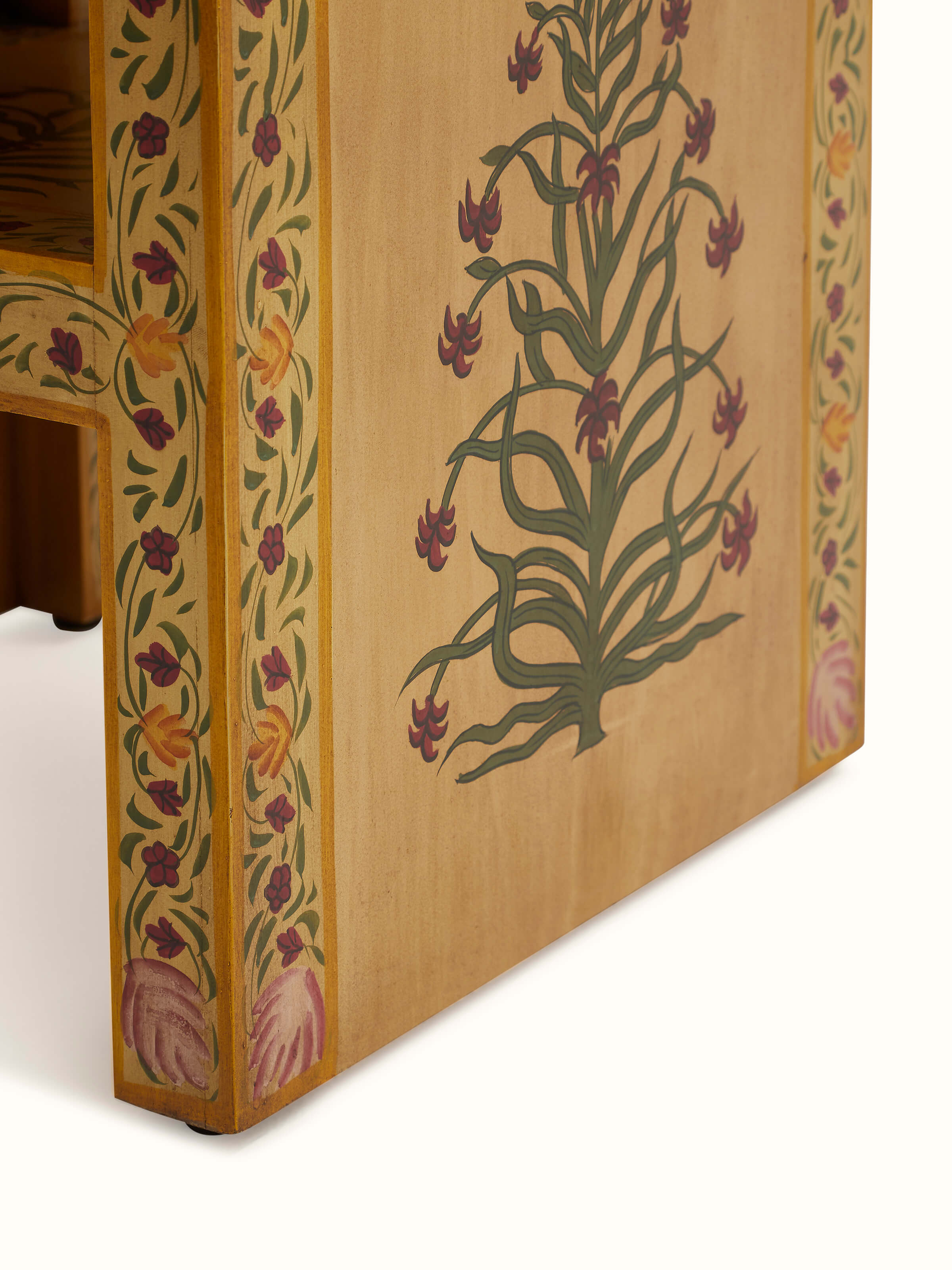 Close-up of miniature painted end table, showcasing the delicate hand-painted patterns and fine details.