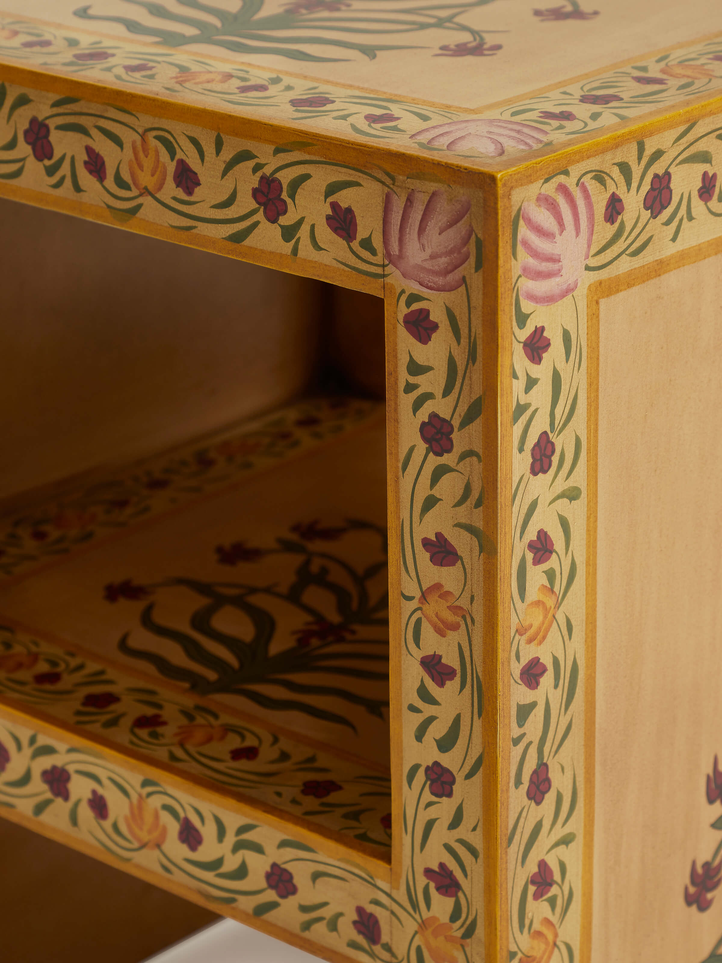Top view of miniature painted end table, highlighting the intricate designs on the tabletop.