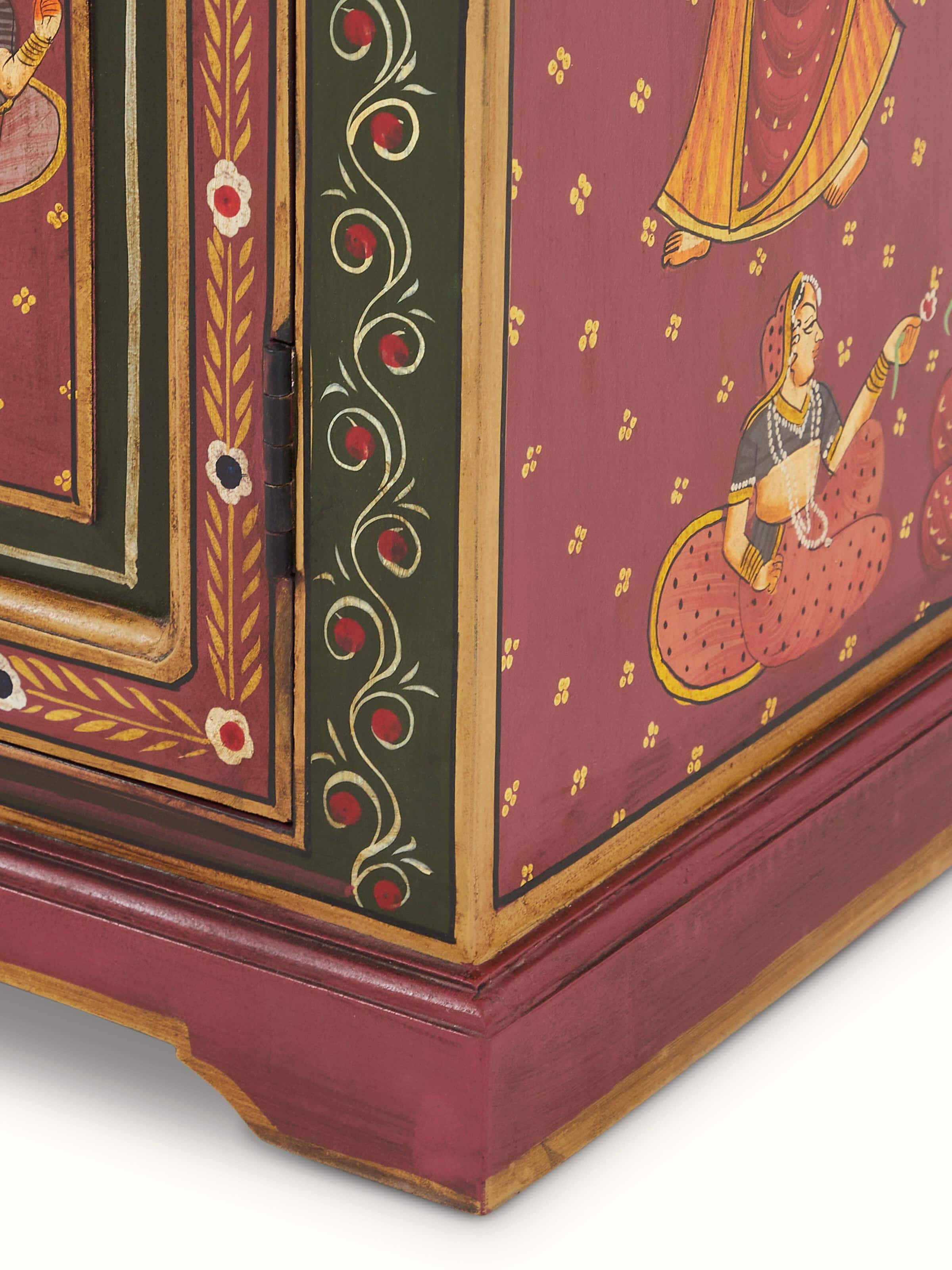 Detailed view of the miniature painted wardrobe's surface, highlighting the intricate patterns and designs.