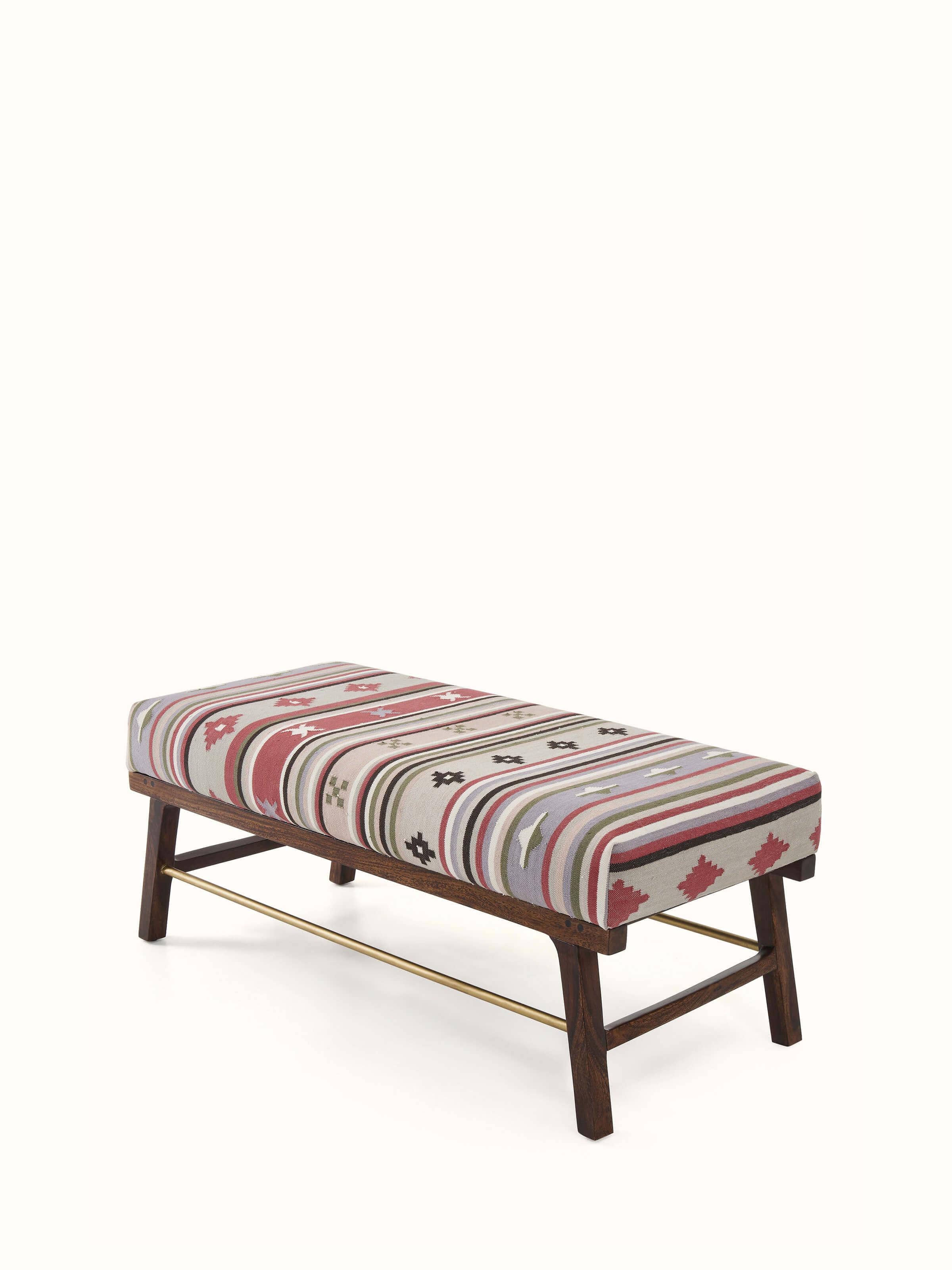 Angled view of the Panja Dhurrie upholstered Sheesham wood bench, emphasizing the detailed woodwork and fabric pattern