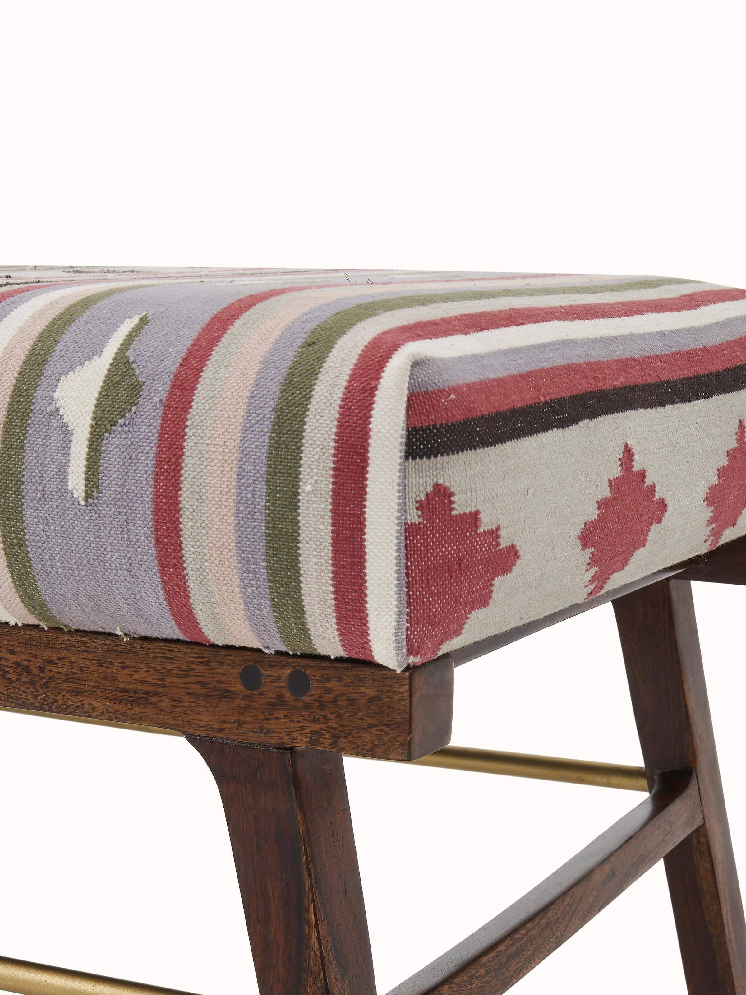 Close-up of the Panja Dhurrie upholstered Sheesham wood bench, focusing on the texture and craftsmanship of the upholstery