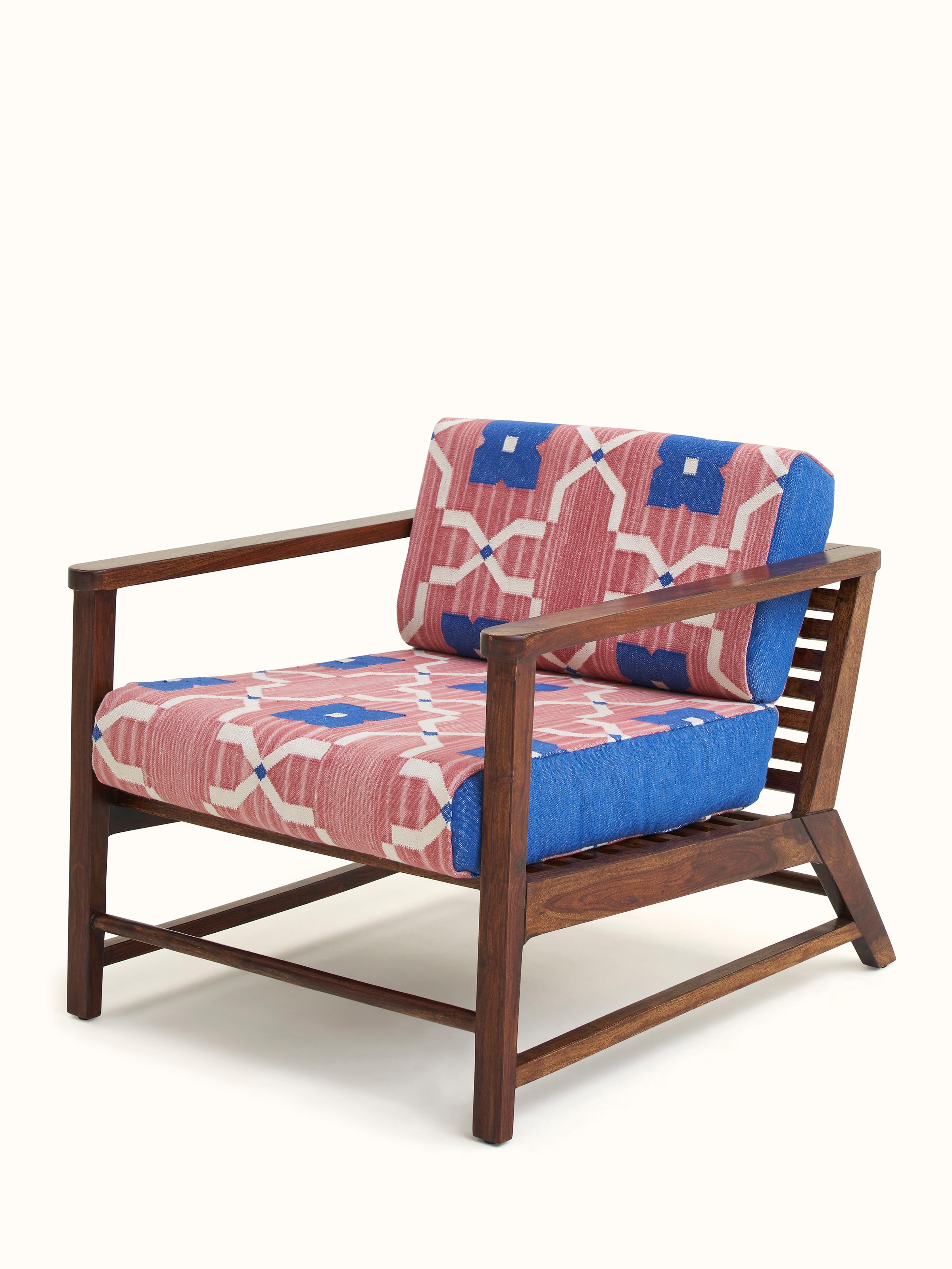 Angled view of Panja Dhurrie Upholstered Sheesham Wood Lounge Chair with Arm highlighting upholstery and armrests