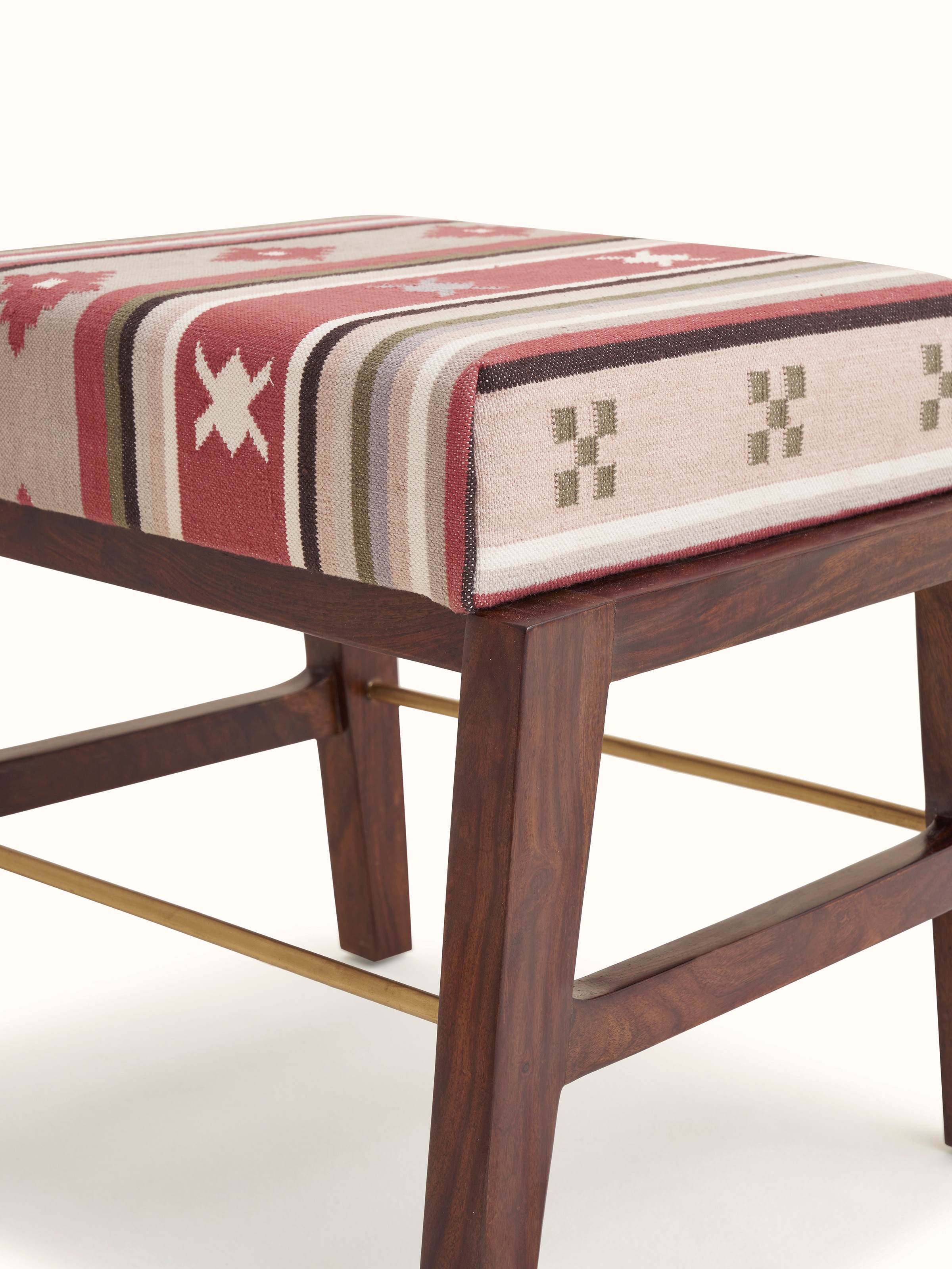 Detailed view of the ottoman's base and metal connector, showcasing the craftsmanship and design of the Sheesham wood ottoman.