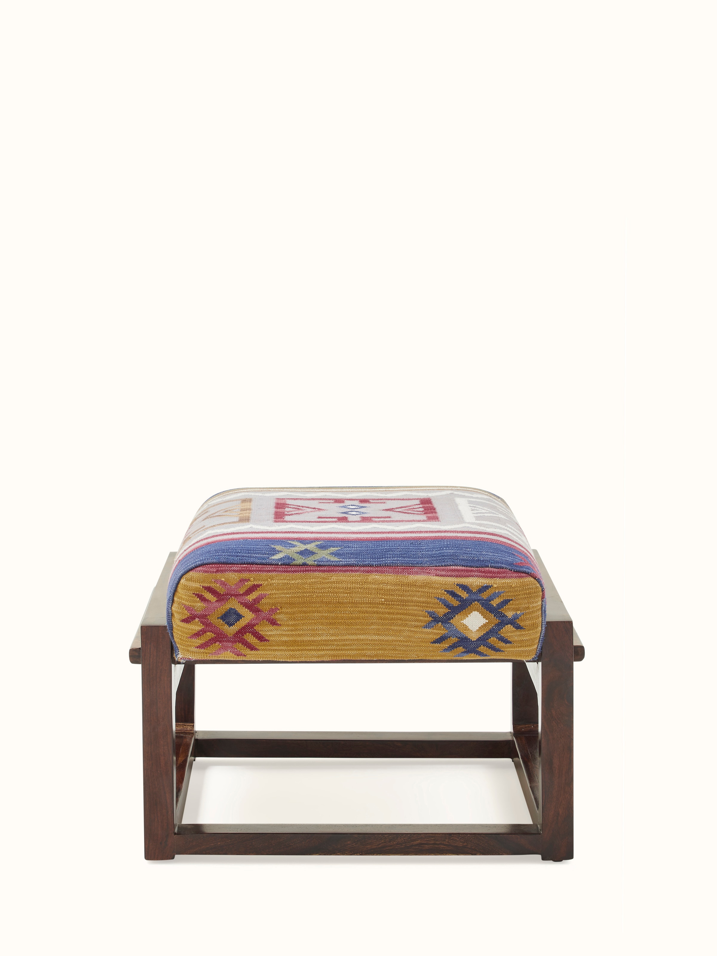 Front view of the Panja Dhurrie upholstered Sheesham wood ottoman, showcasing its traditional pattern and robust construction