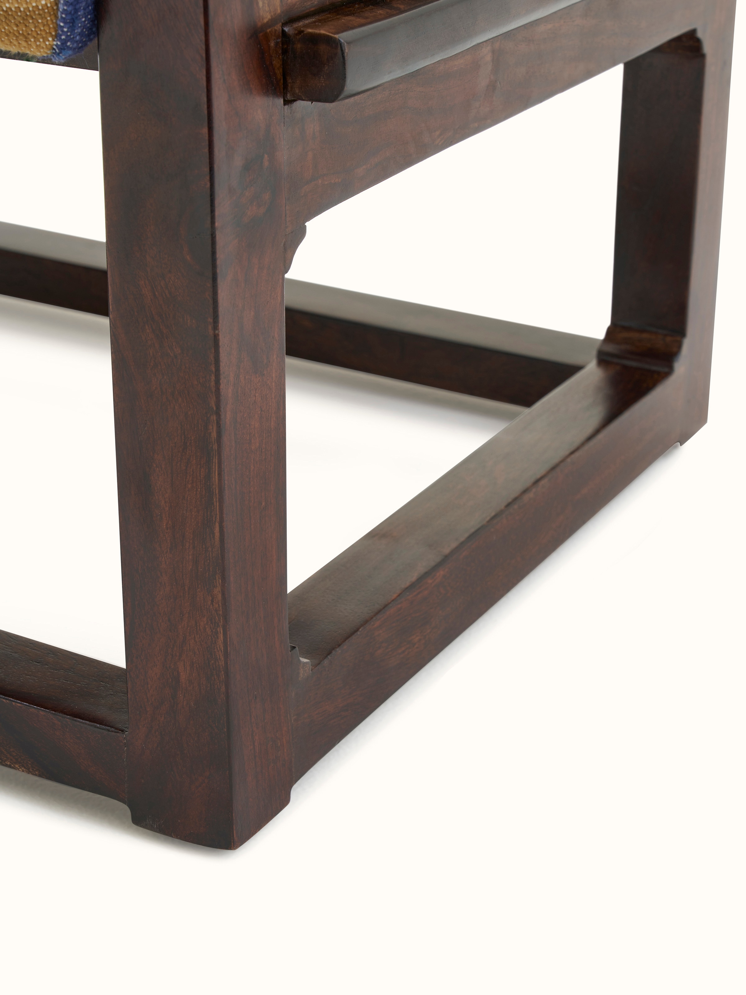 View of the Sheesham wood ottoman in a room setting, demonstrating its versatility and aesthetic appeal in home decor