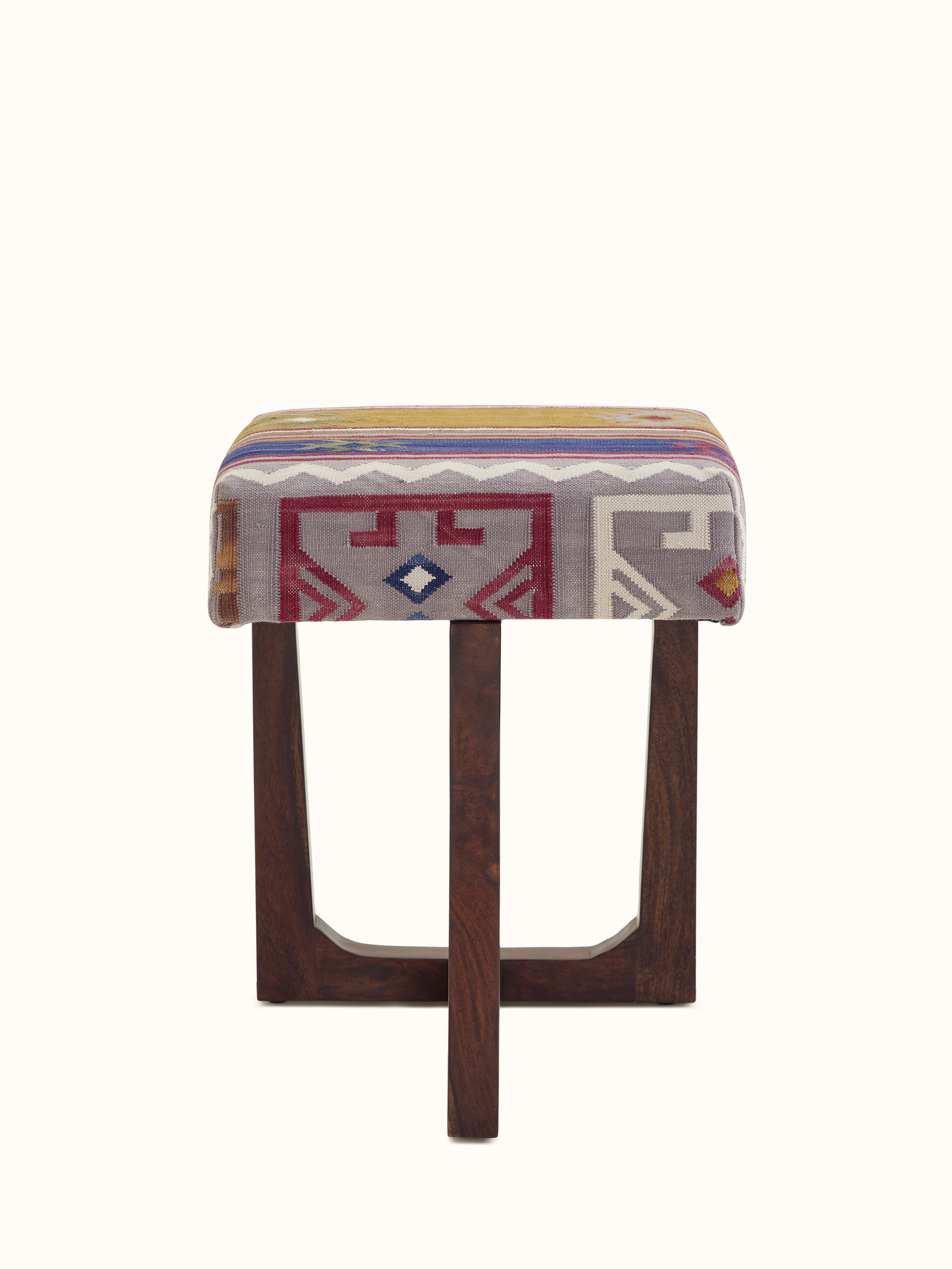 Front view of the Panja Dhurrie upholstered Sheesham wood stool, showcasing the vibrant fabric and sturdy wood construction