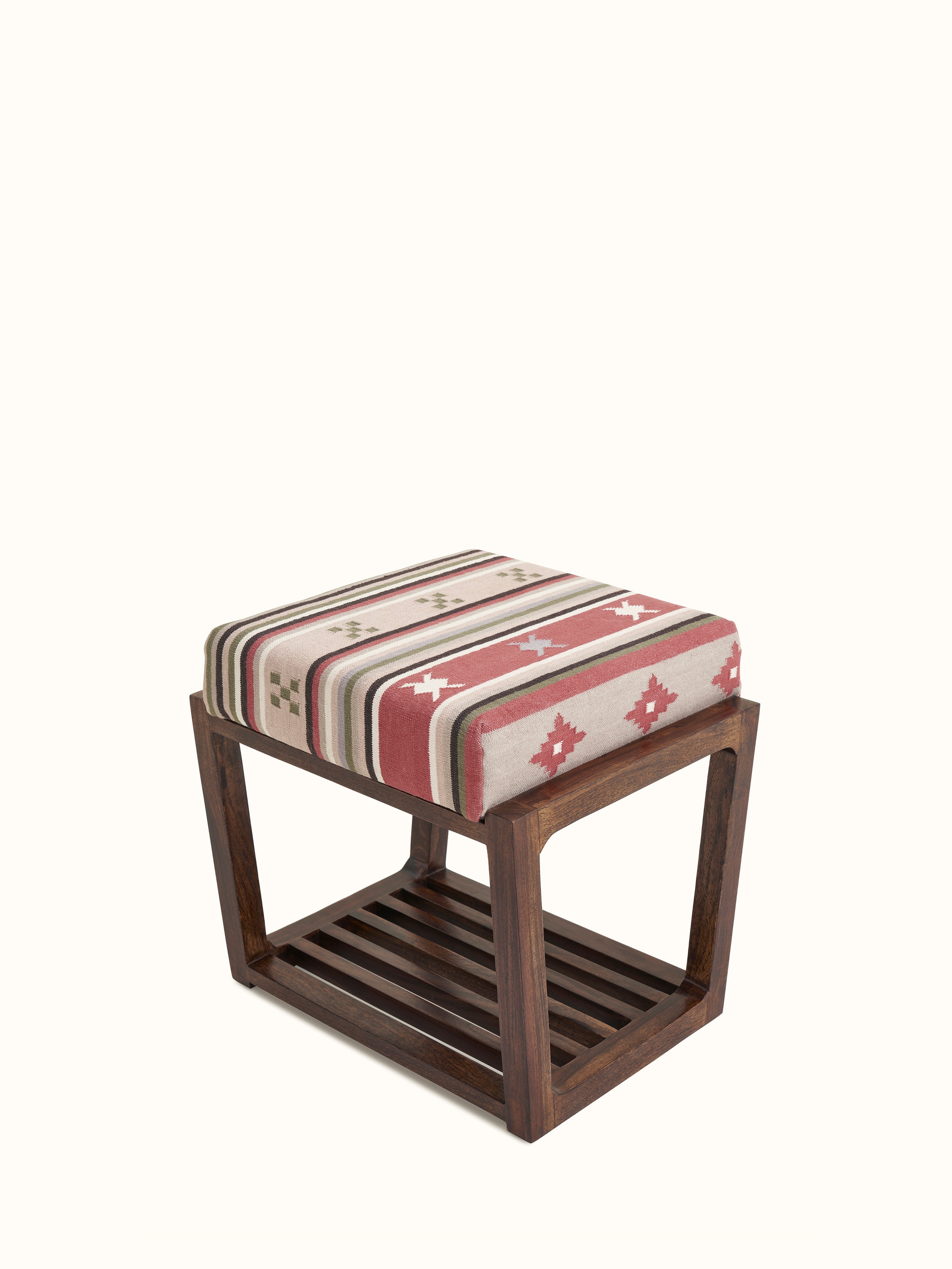 Close-up of the Panja Dhurrie upholstered Sheesham wood stool, highlighting the detailed dhurrie fabric and the stool's wooden slated base.