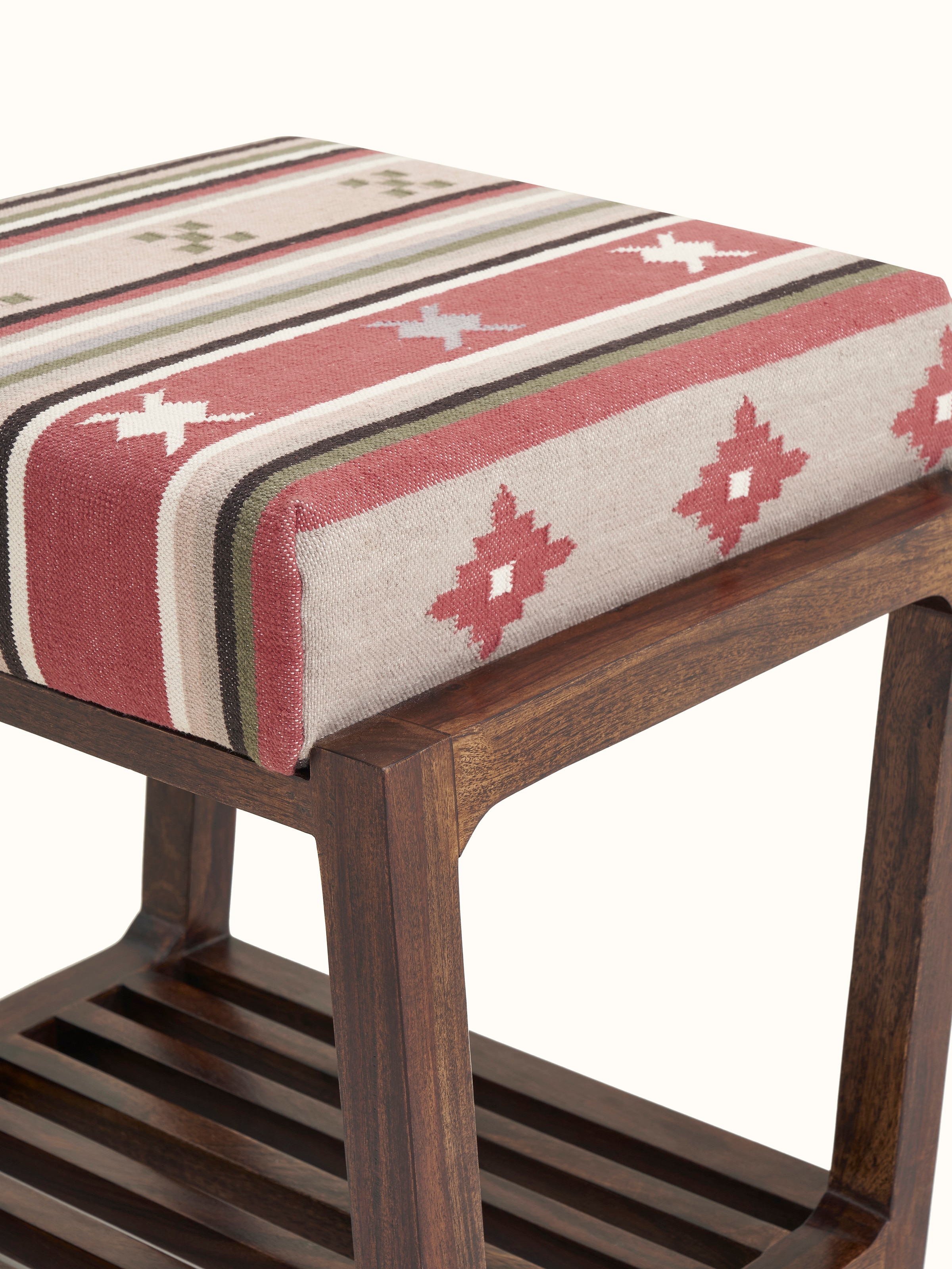 Angle view of the Panja Dhurrie stool with Sheesham wood base, showing the integration of dhurrie upholstery and wooden slats.