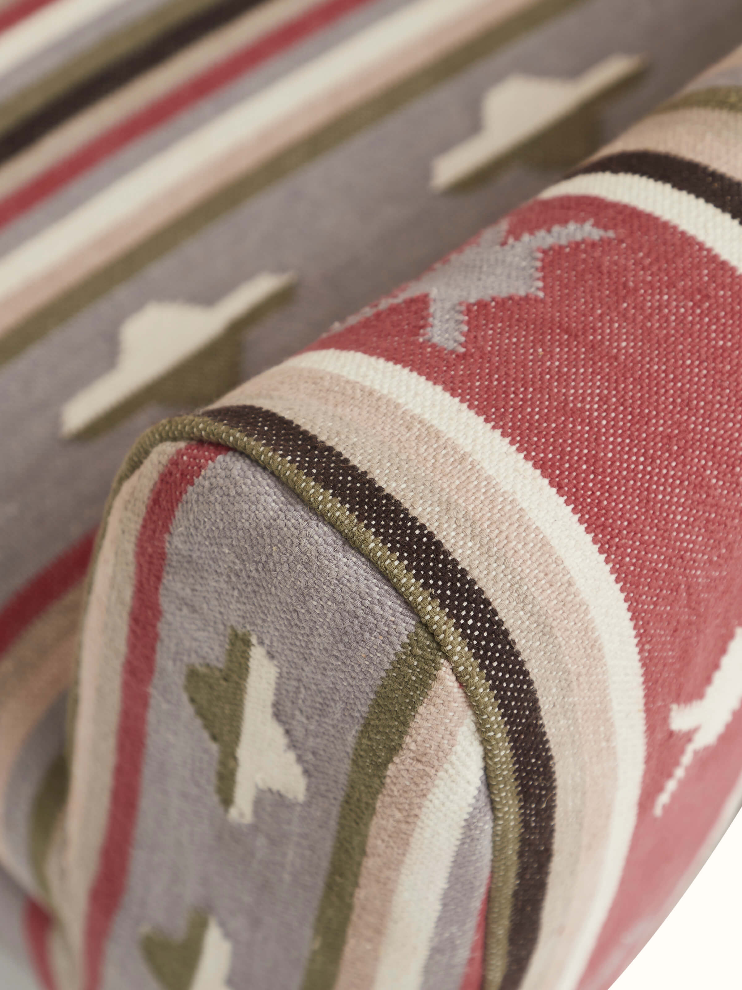 Detailed view of the Panja Dhurrie fabric on Sheesham wood wing chair, focusing on the texture and patterns