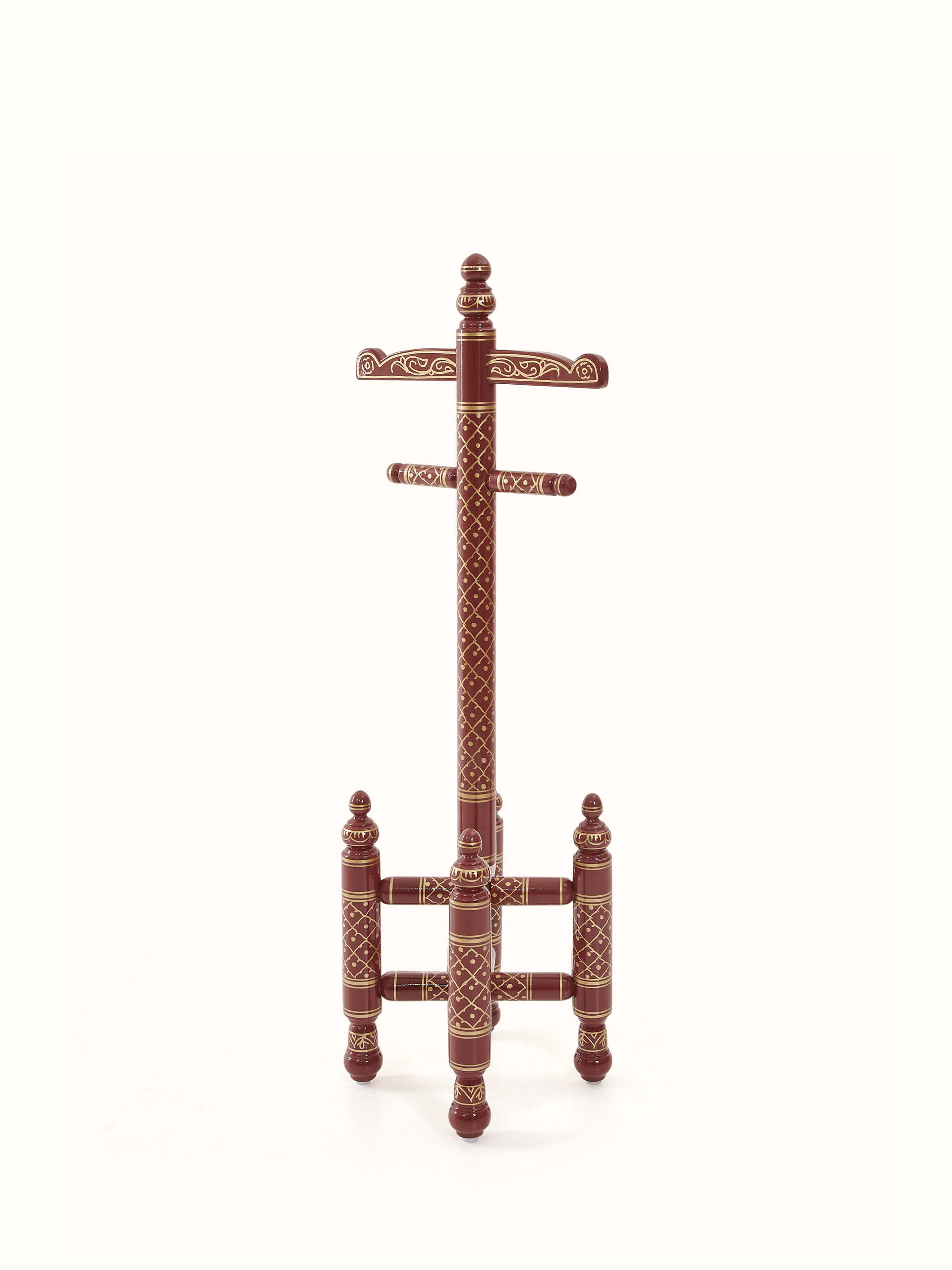 Angled view of teak wood Sankheda maroon coat hanger, highlighting the detailed carvings and sturdy structure.