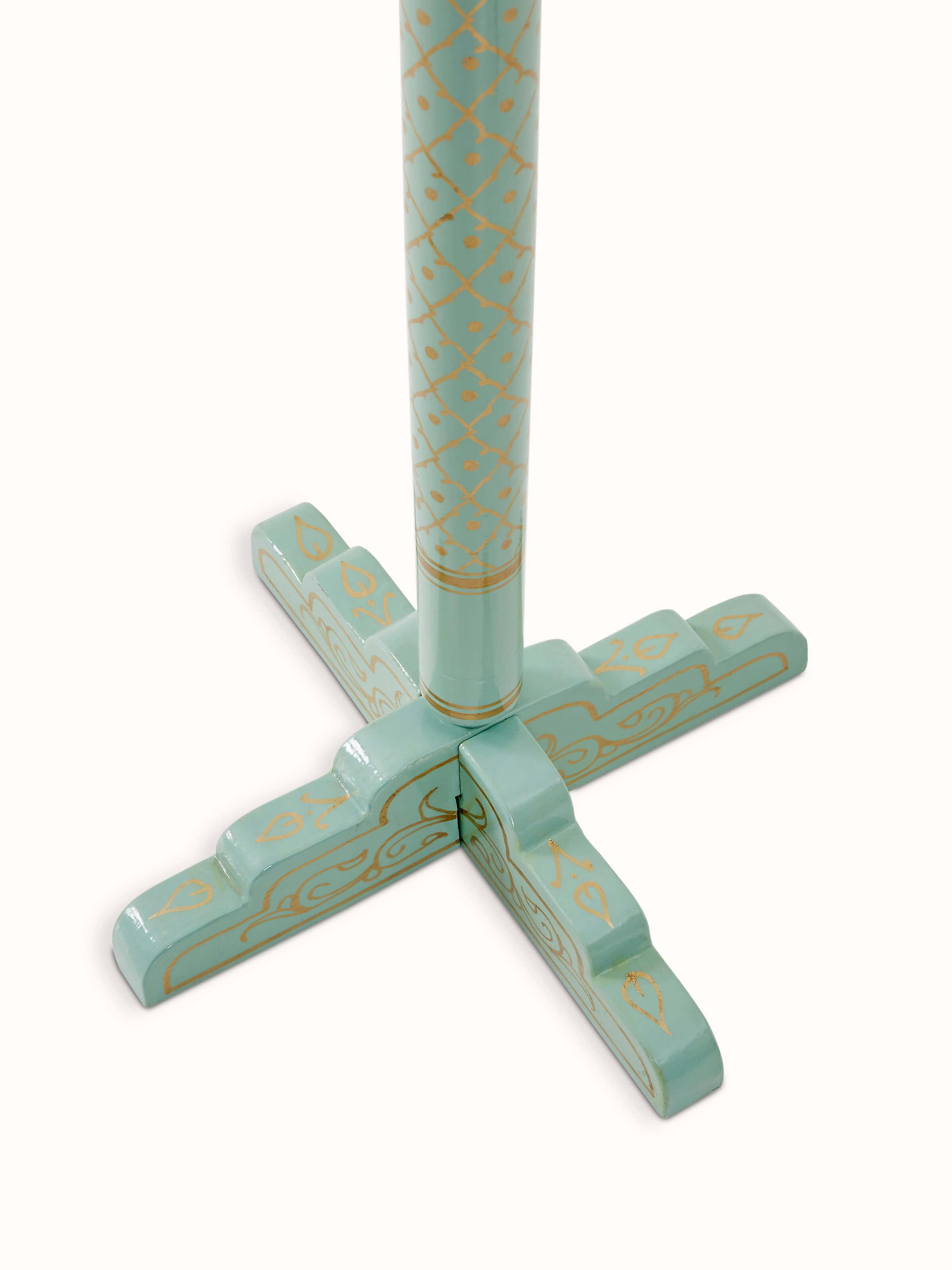 Angle view of Teak Wood Sankheda Aqua Coat Hanger, showcasing the detailed carving and color contrast