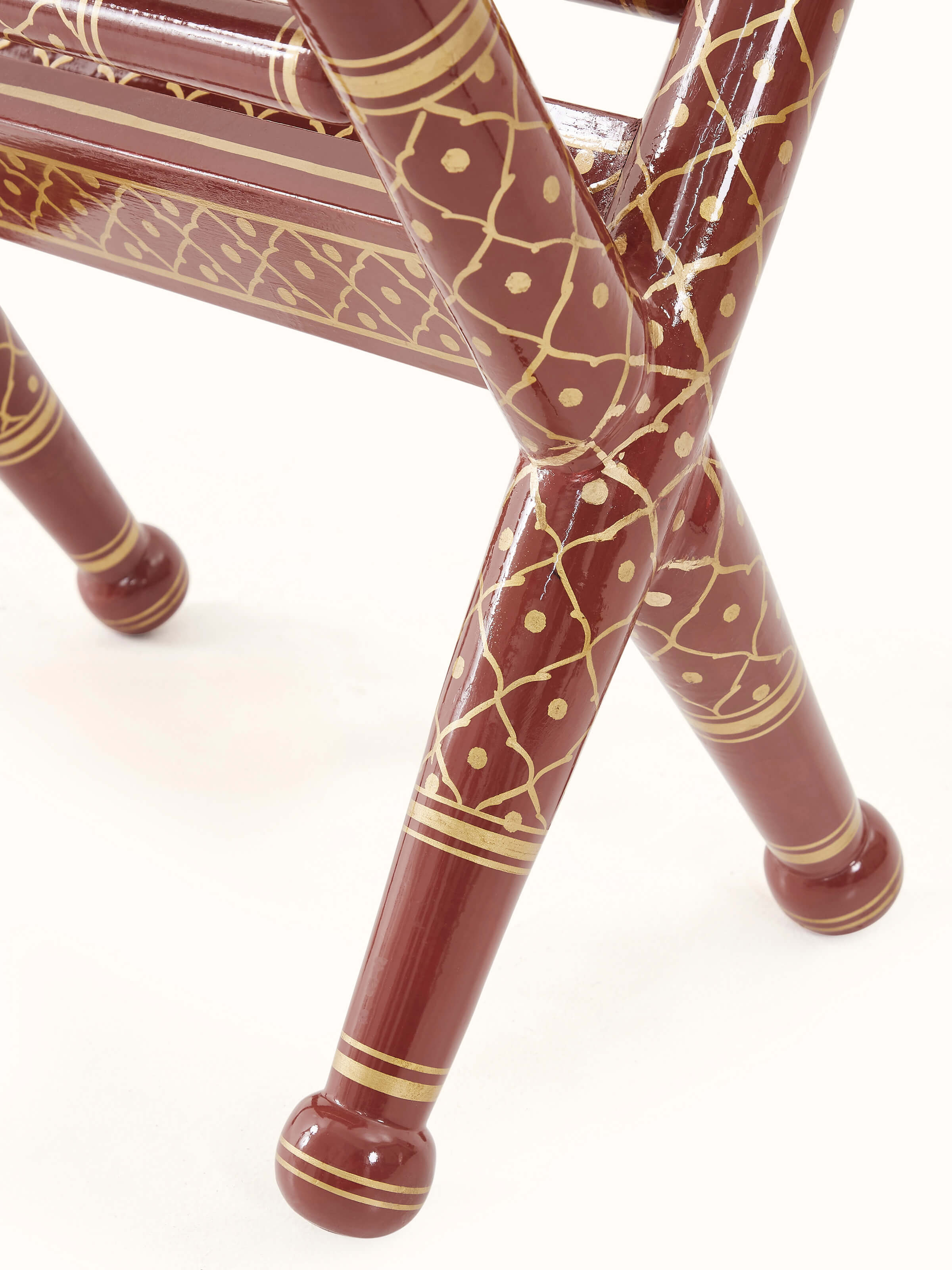 Angle view of Teak Wood Sankheda Cross Leg Magazine Rack, emphasizing the cross-leg design and practical magazine storage