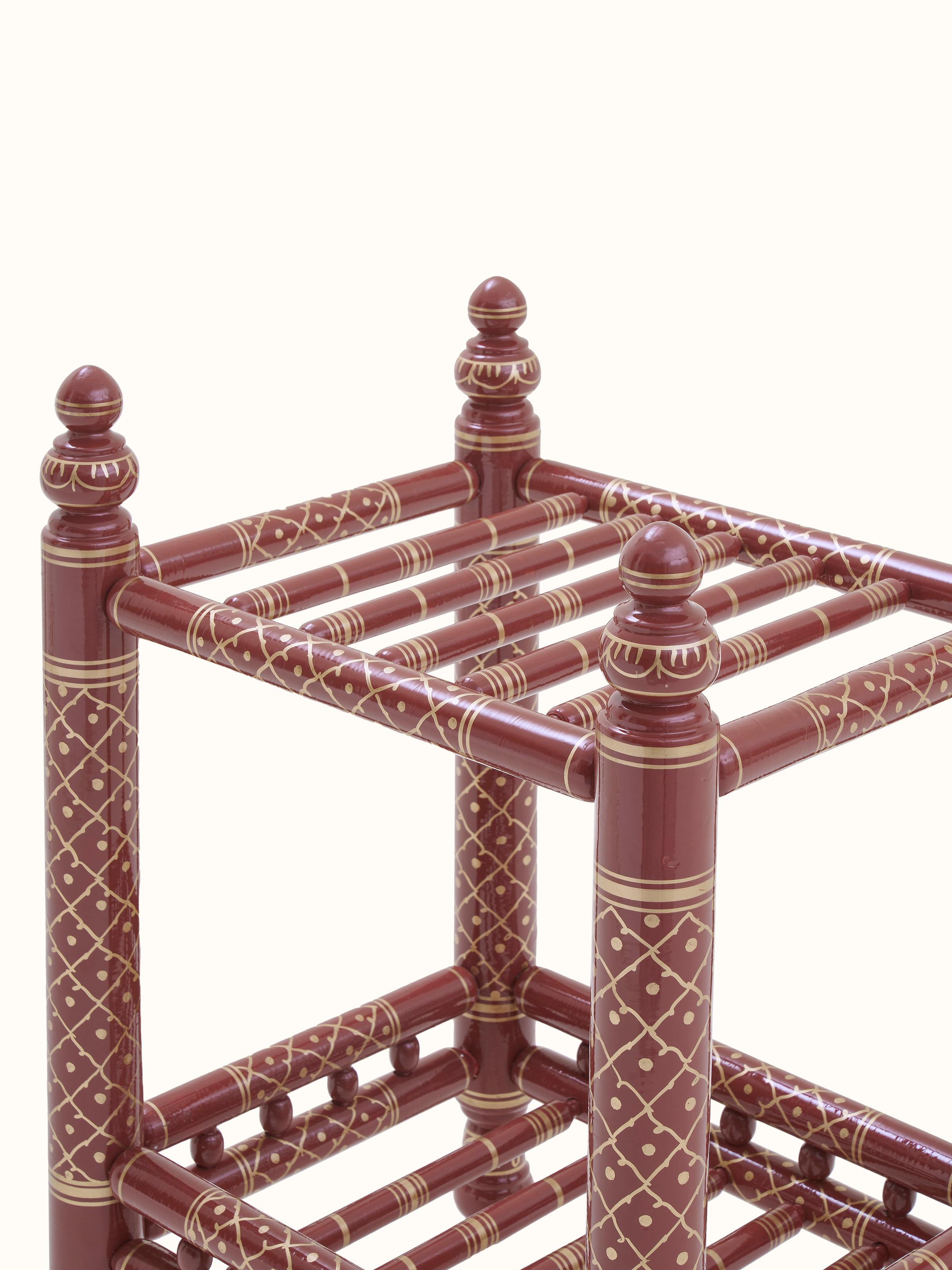 Angled view of the teak wood Sankheda magazine rack, showing the magazine storage compartments and decorative elements