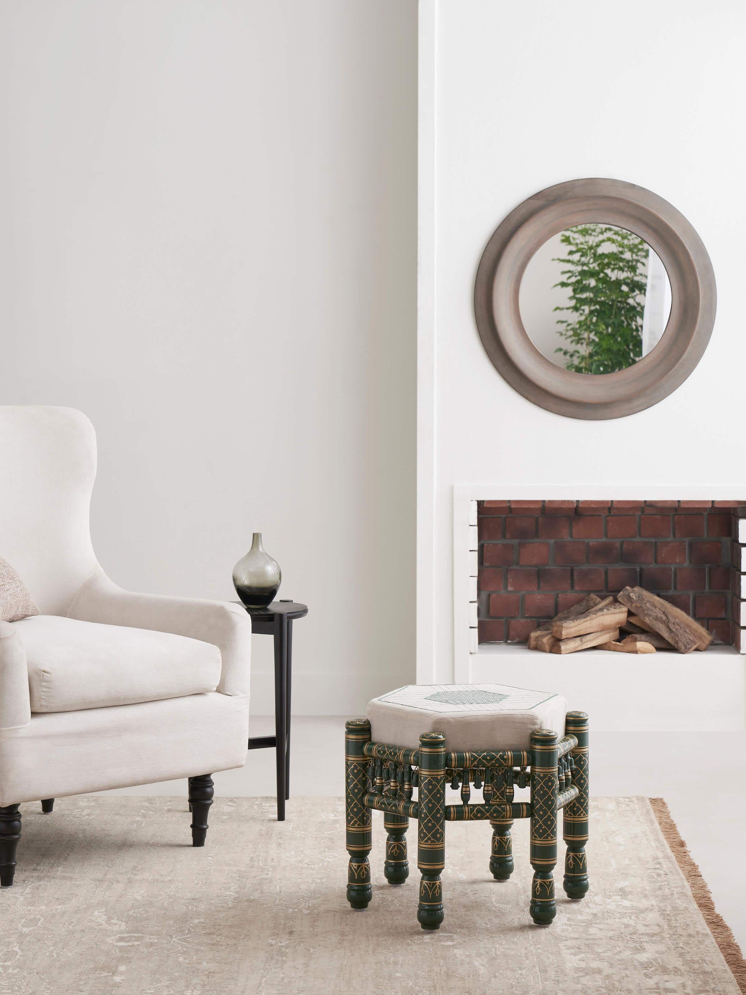 Side view of Upholstered teak wood Sankheda octagonal pouffe highlighting rich upholstery