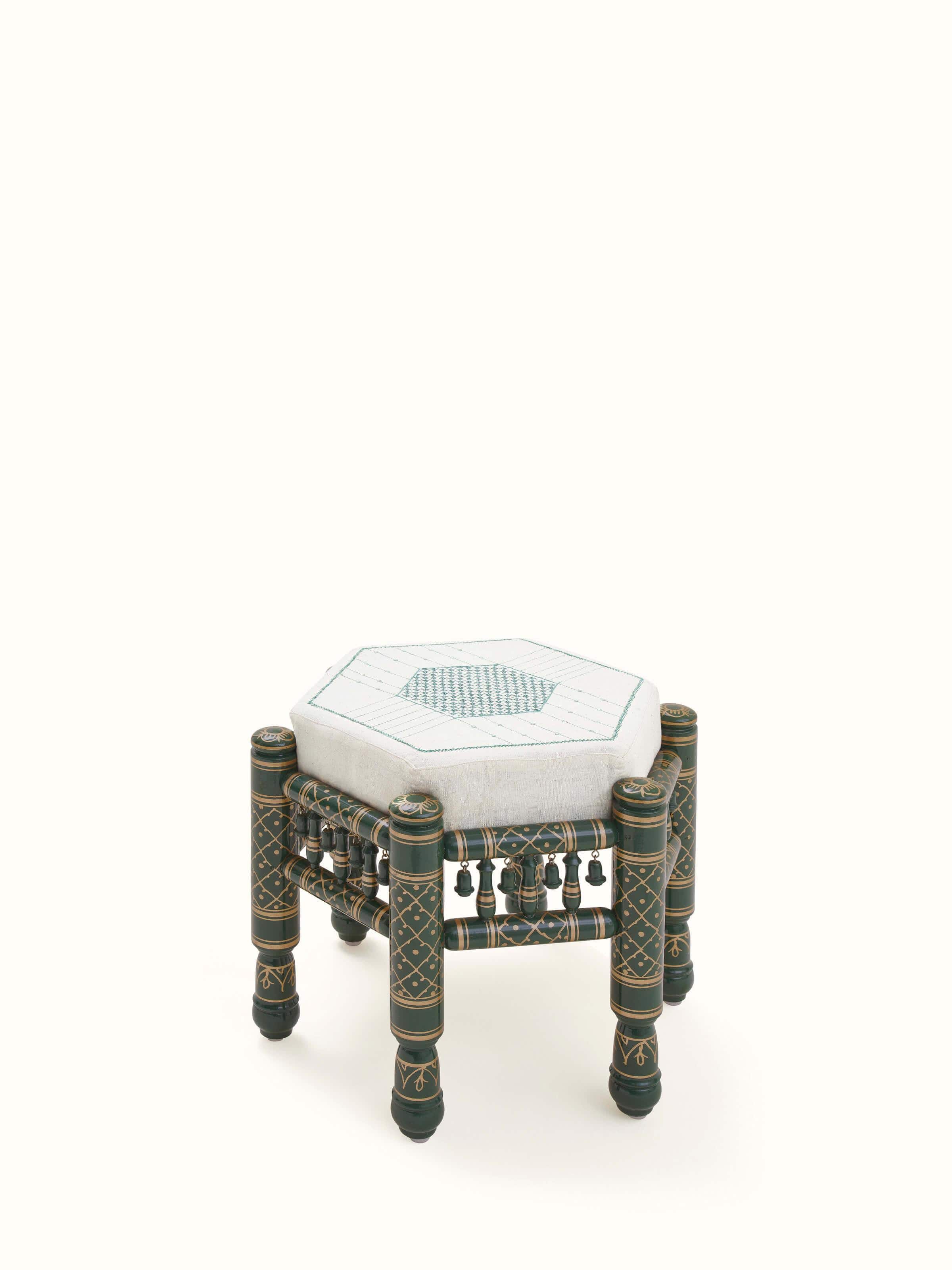 Angled view of Upholstered teak wood Sankheda octagonal pouffe showing intricate craftsmanship