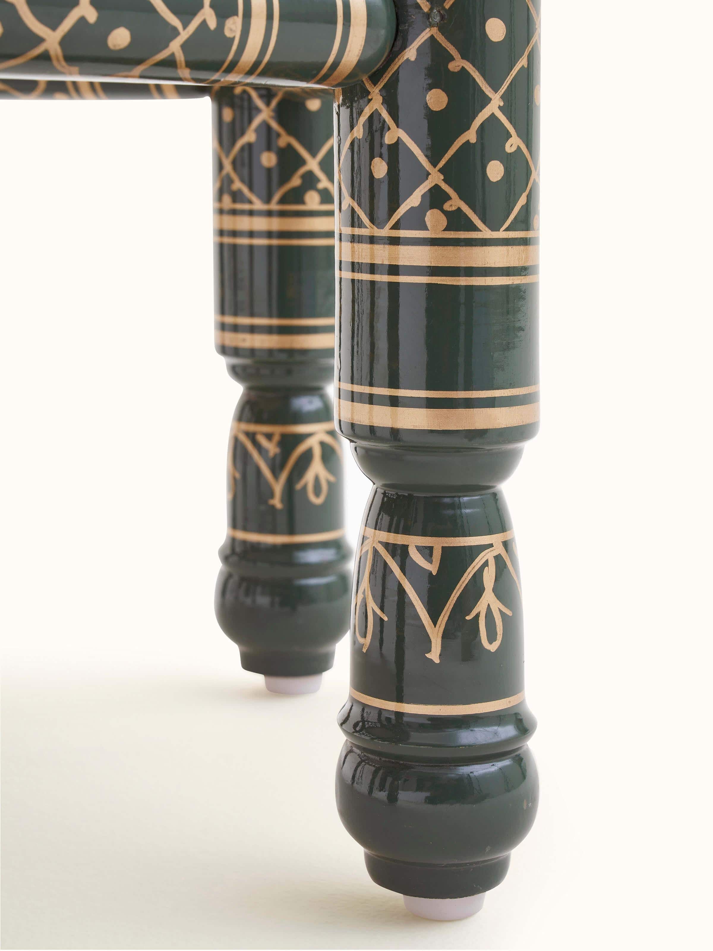 Detail shot of Upholstered teak wood Sankheda octagonal pouffe highlighting exquisite woodwork