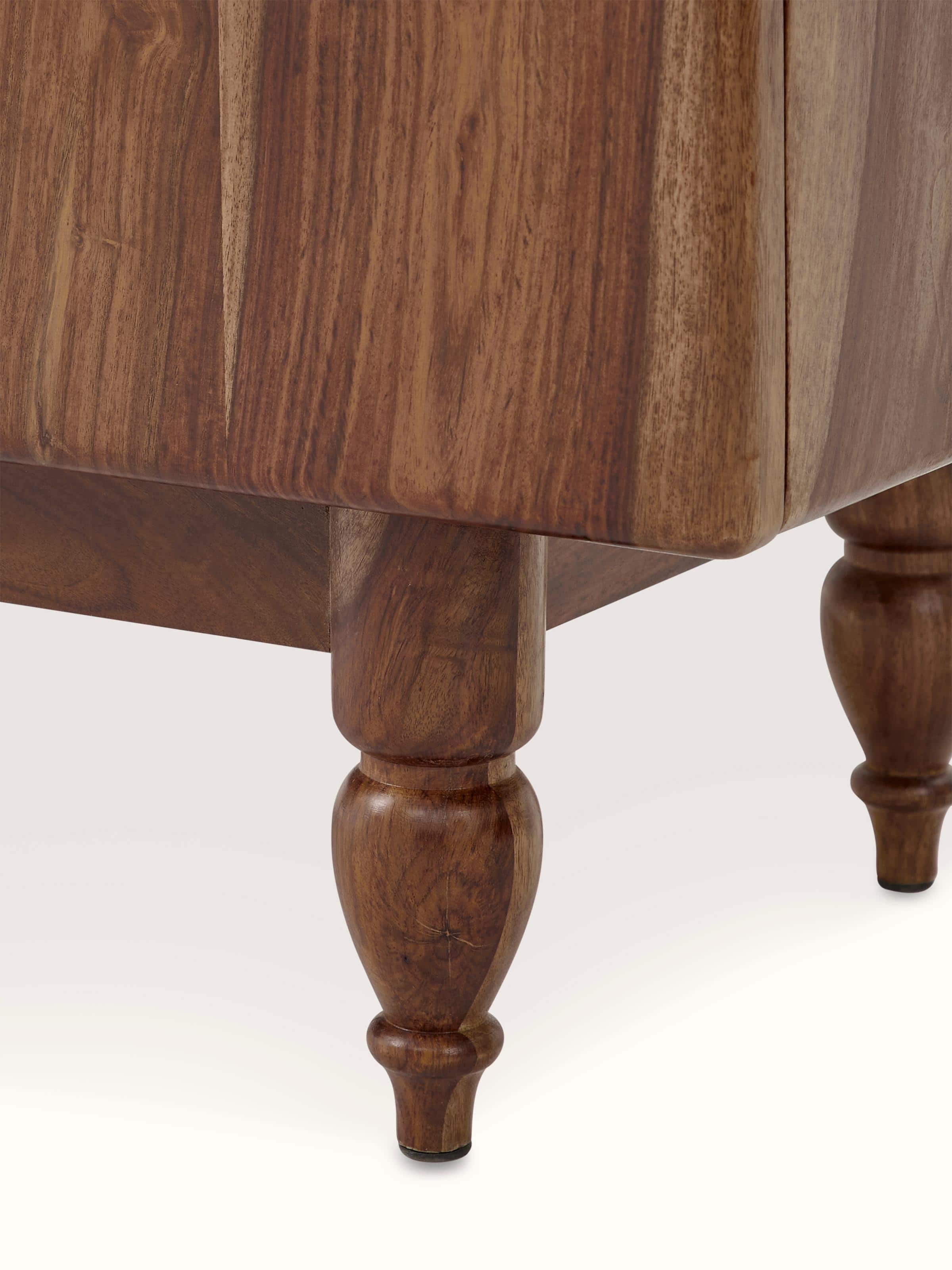 Close-up view of walnut finish carved marble & sheesham wood sideboard highlighting detailed artwork