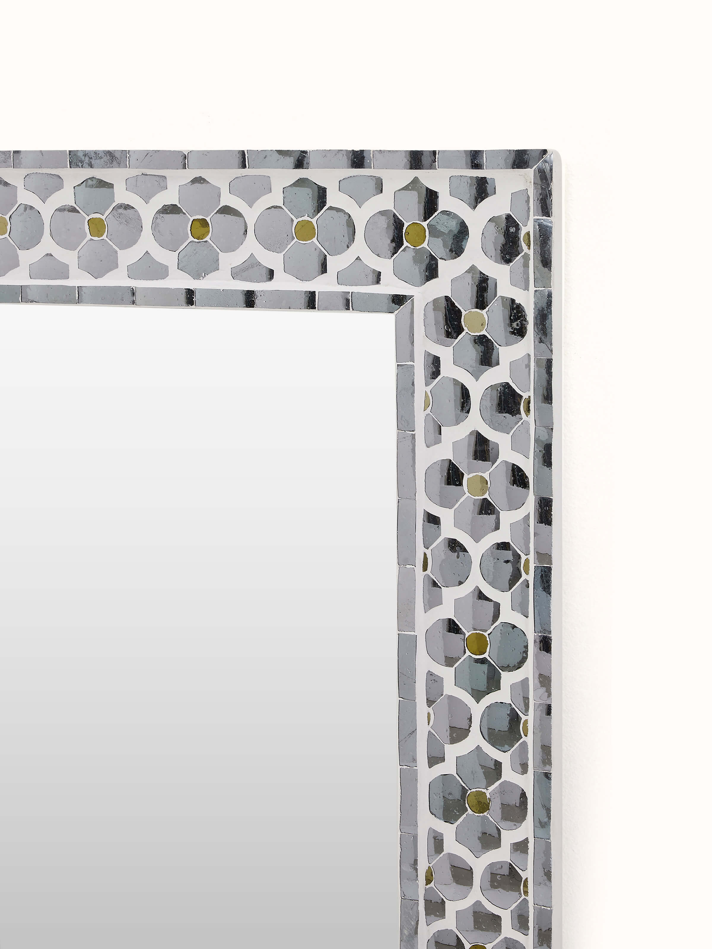 Side view of the glass floral inlay mirror, demonstrating its depth and elegant profile