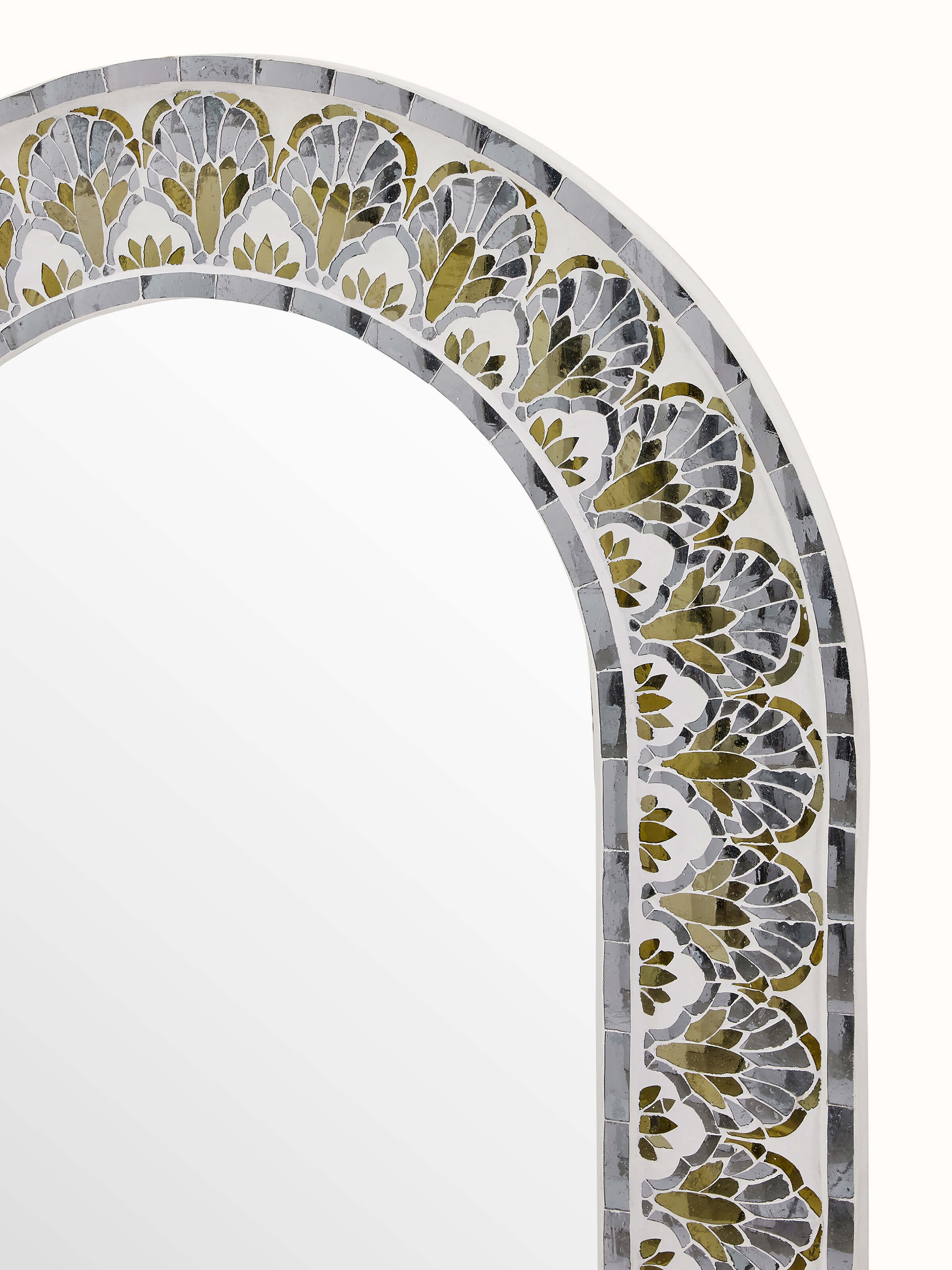 Close-up of floral inlay on oval full-length mirror, emphasizing intricate design and elegant glasswork.