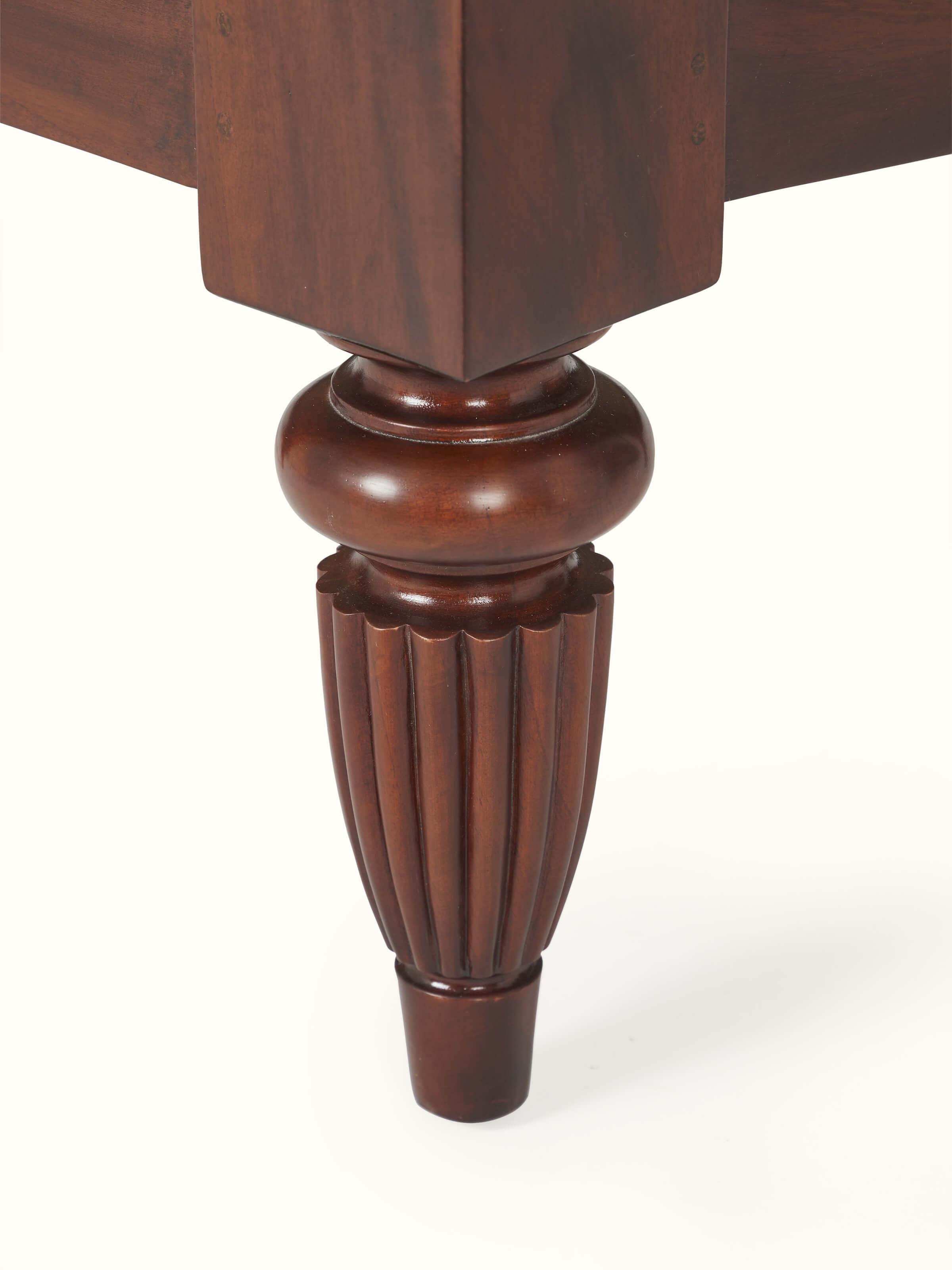 Angled view of upholstered mahogany wood & cane armchair, showing the combination of wood and cane details