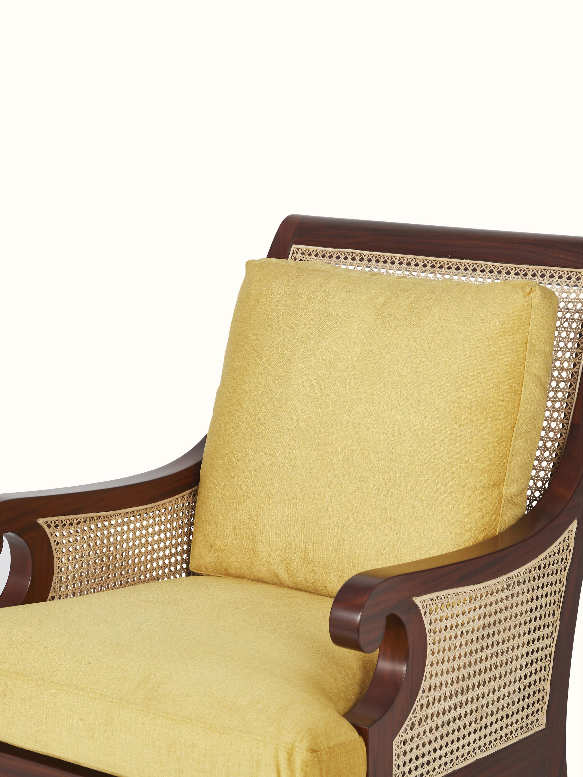 Close-up of the seat cushion on upholstered mahogany wood & cane armchair, showing comfortable upholstery