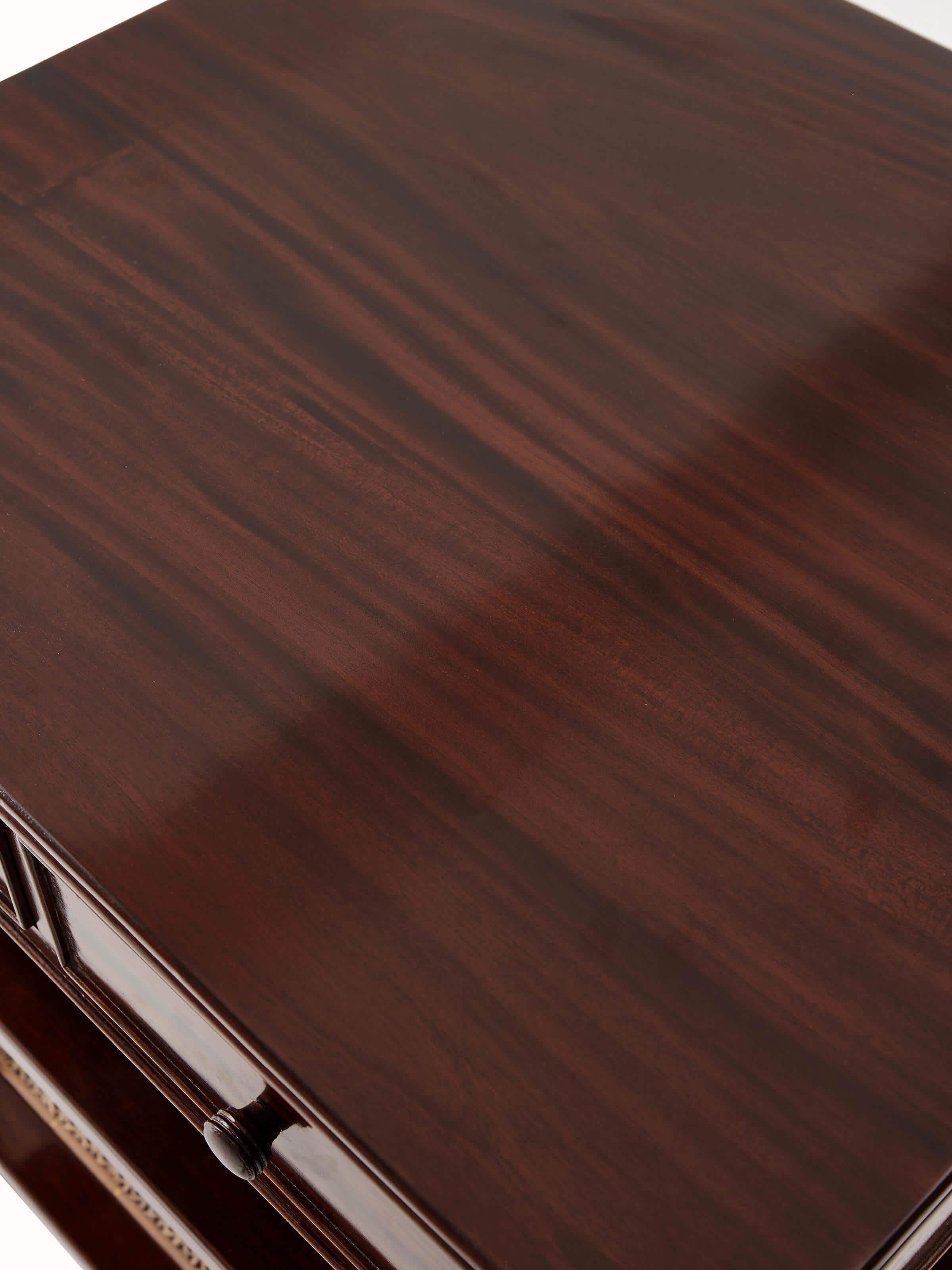 Angle view of the mahogany wood and cane bedside table, showcasing the combination of wood and cane materials.