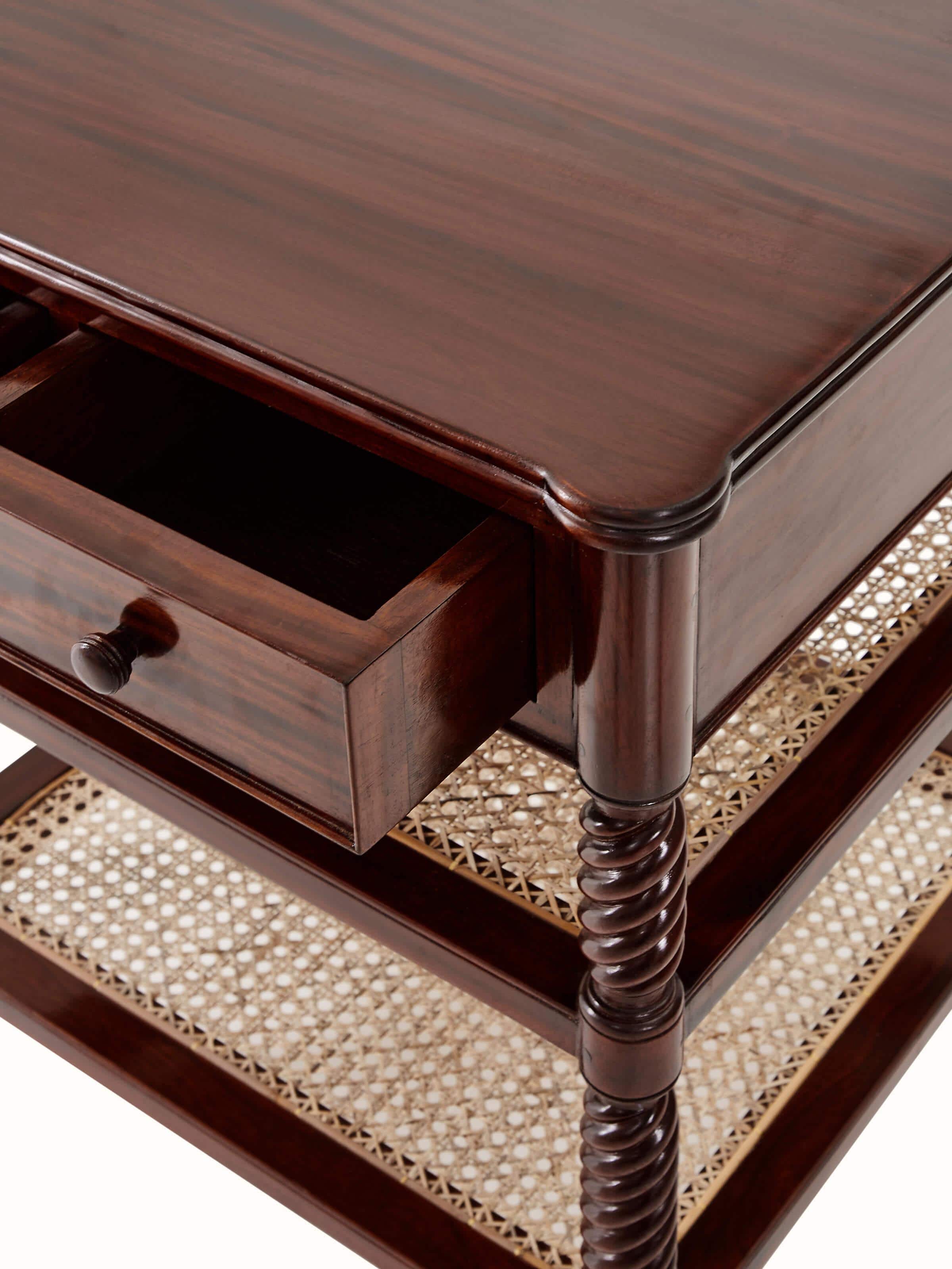 Front view with focus on the drawer handle of the mahogany wood and cane bedside table, showing the fine detailing.