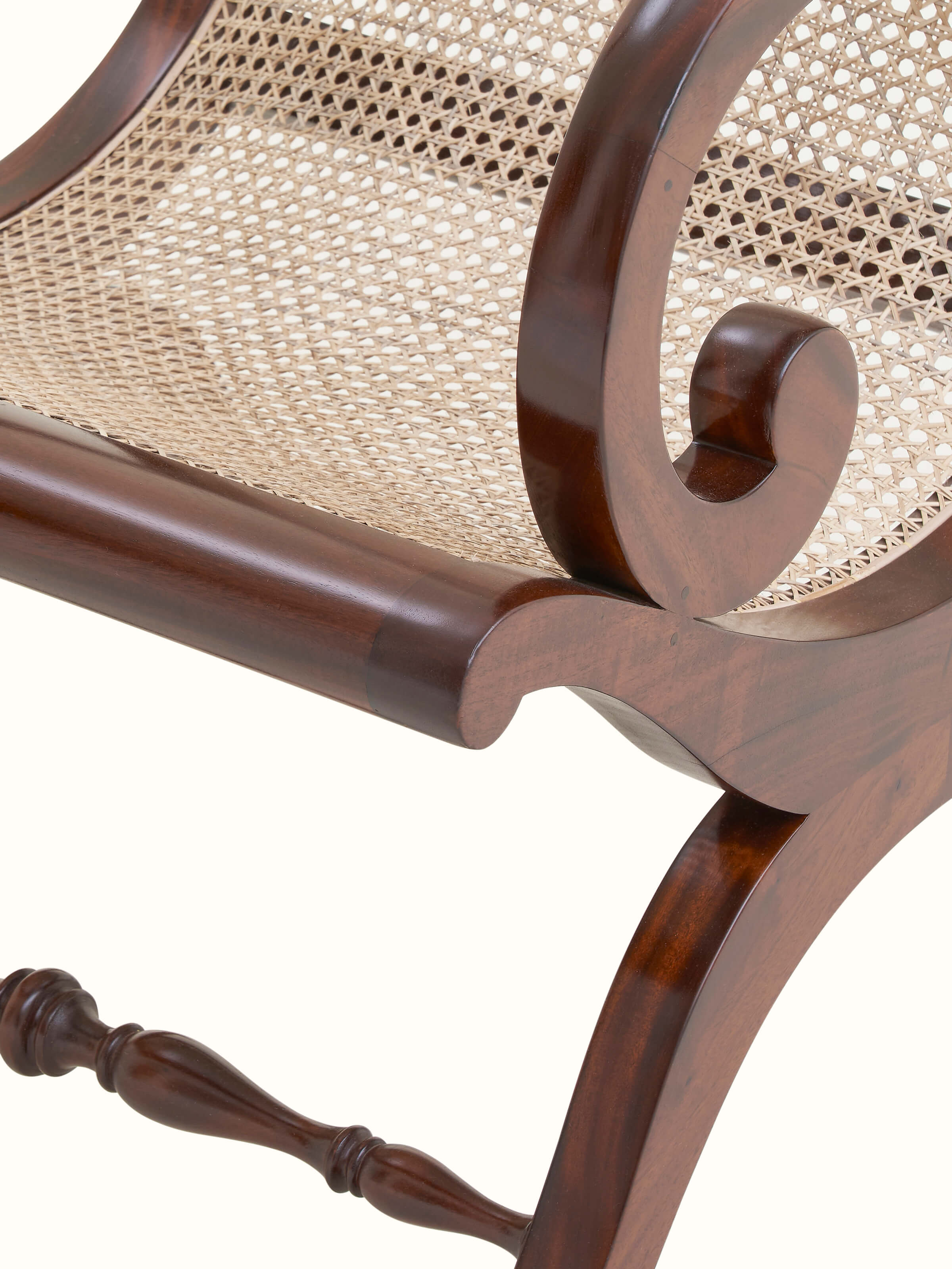 Detailed shot of the armrest and cane work on the Mahogany wood wing chair, emphasizing the quality craftsmanship