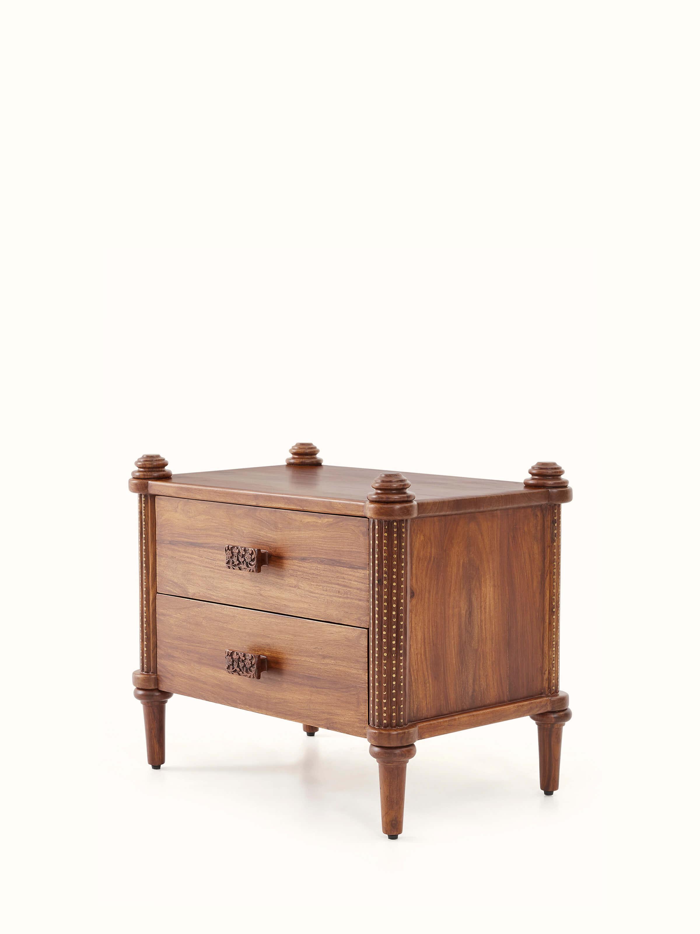 Angle view of Carved Sheesham Wood Bedside Table emphasizing detailed carvings and sturdy construction.