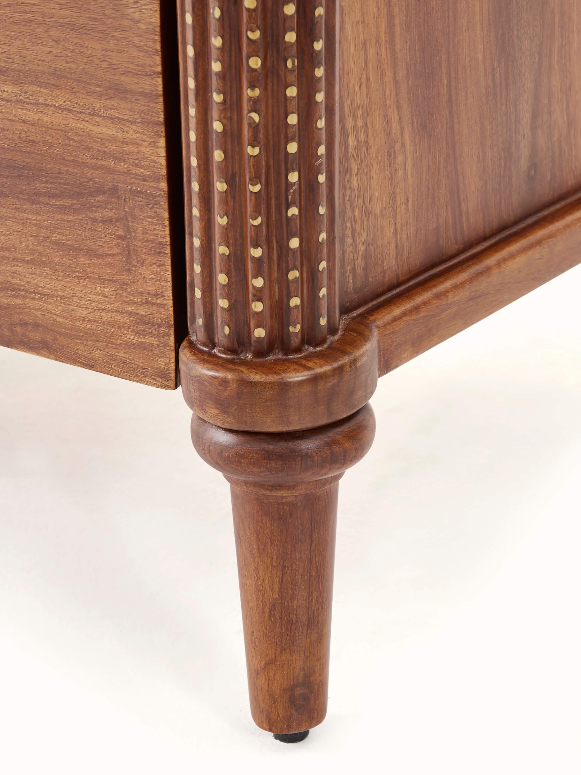 Close-up view of Carved Sheesham Wood Bedside Table showing an open drawer and showcasing fine wood detailing.