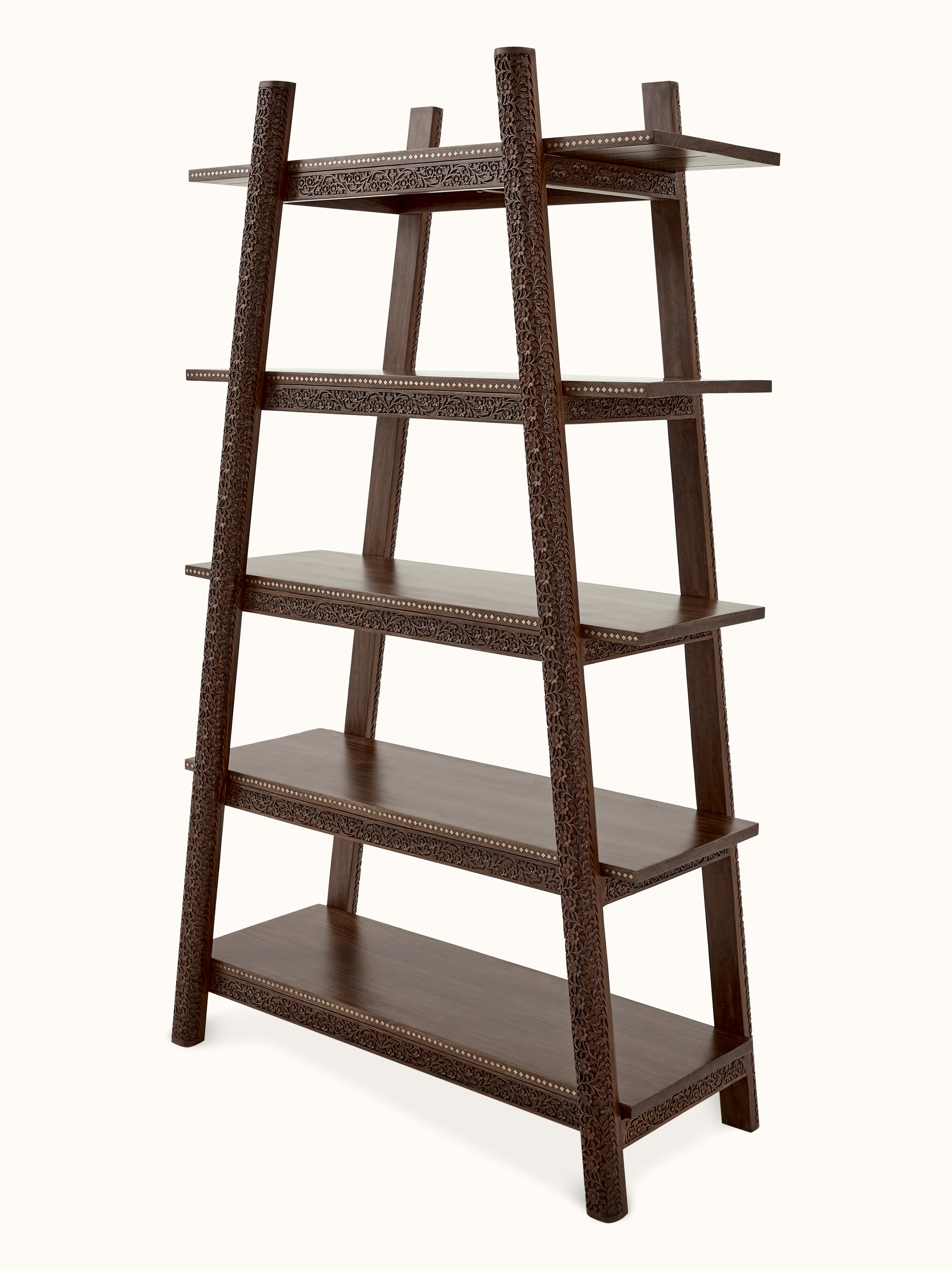 Angled view of carved sheesham wood bookshelf, showing elegant carvings and ample storage space