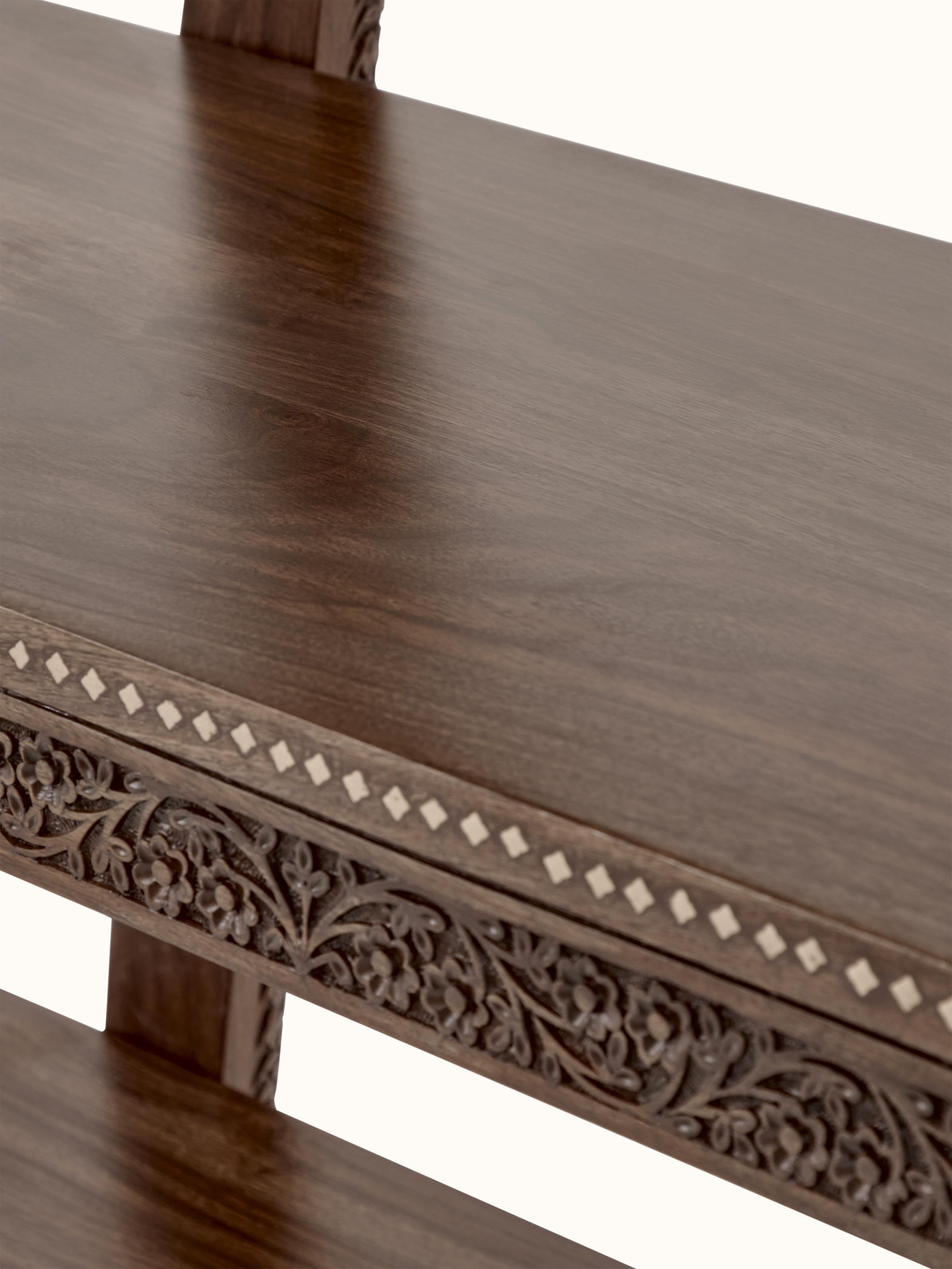 Interior view of carved sheesham wood bookshelf, showcasing shelf layout and storage capacity