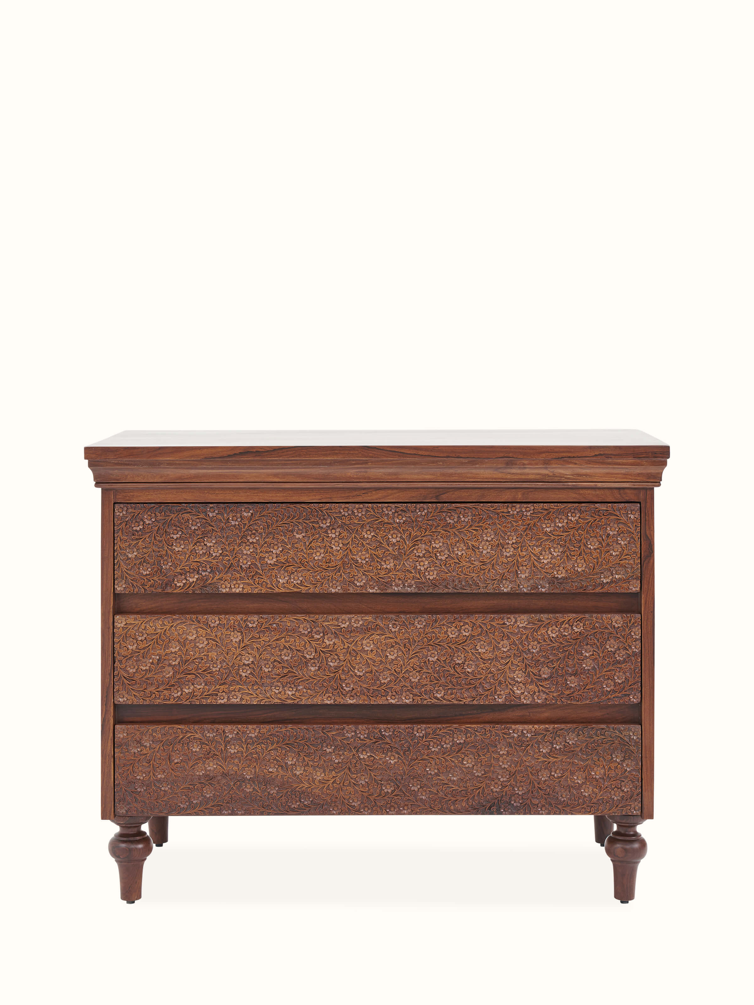 Front view of Carved Sheesham Chest of Drawers displaying detailed carvings and rich wood finish.