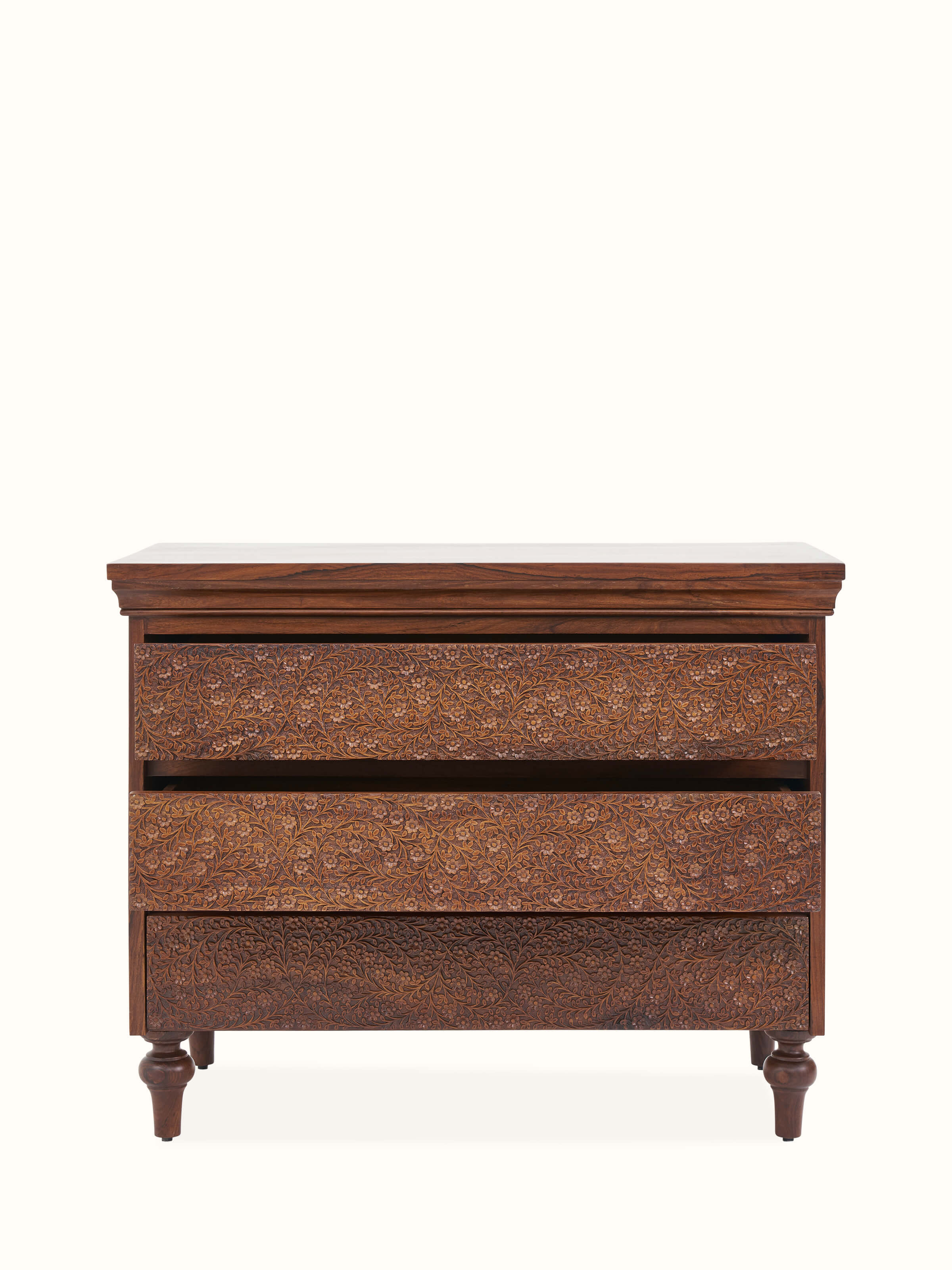 Detailed view of Carved Sheesham Chest of Drawers highlighting the intricate woodwork and refined finish.